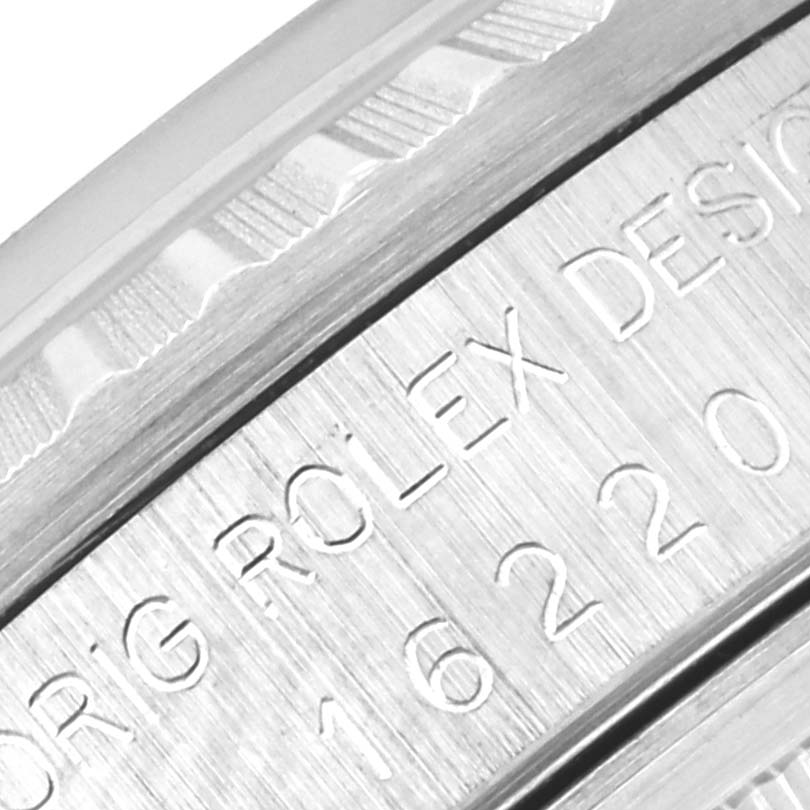 The image shows a close-up of the engraving on the side of the bezel of a Rolex Datejust 16220 Men's Stainless Steel Silver Dial 16220 Men's Stainless Steel Silver Dial watch.