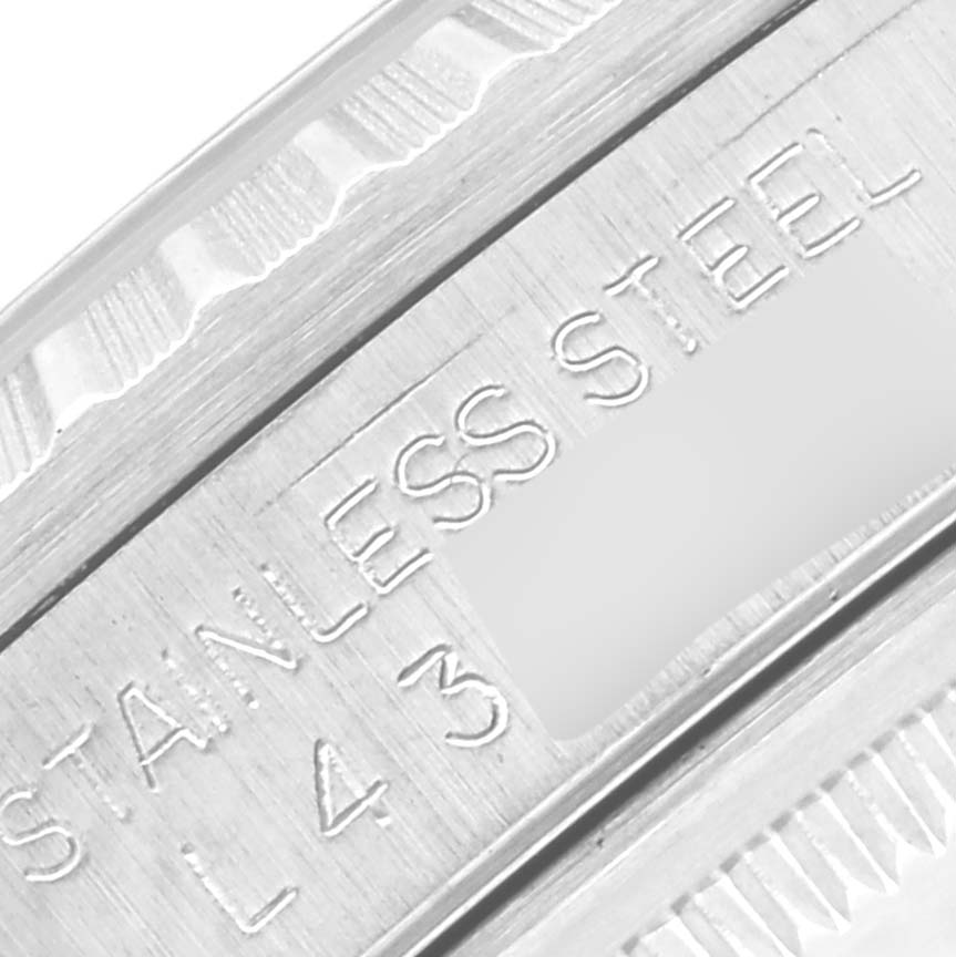 The image shows an extreme close-up of the stainless steel caseback and edge of the Rolex Datejust 16220 Men's Stainless Steel Silver Dial 16220 Men's Stainless Steel Silver Dial model.