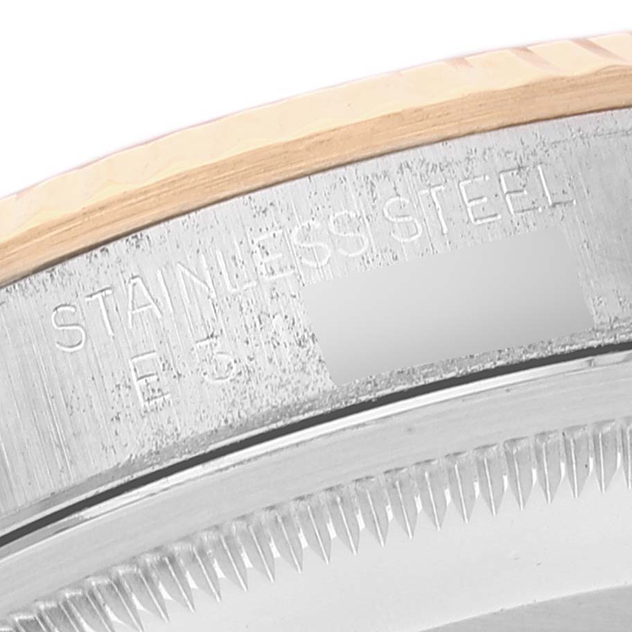 This image shows a close-up of the case back and part of the bezel of a Rolex Datejust 16233 Men's Steel and Gold (two tone) White Dial 16233 Men's Steel and Gold (two tone) White Dial watch.