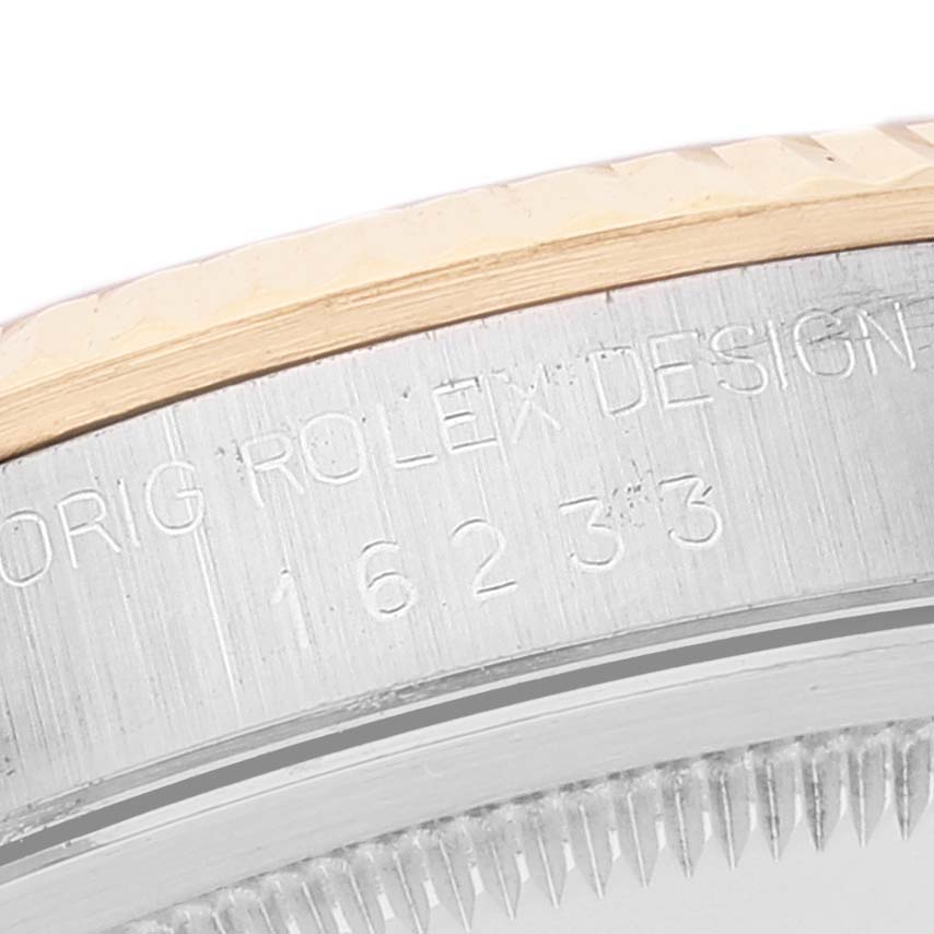 The image shows a close-up view of the engraved caseback and part of the bezel of the Rolex Datejust 16233 Men's Steel and Gold (two tone) White Dial 16233 Men's Steel and Gold (two tone) White Dial.