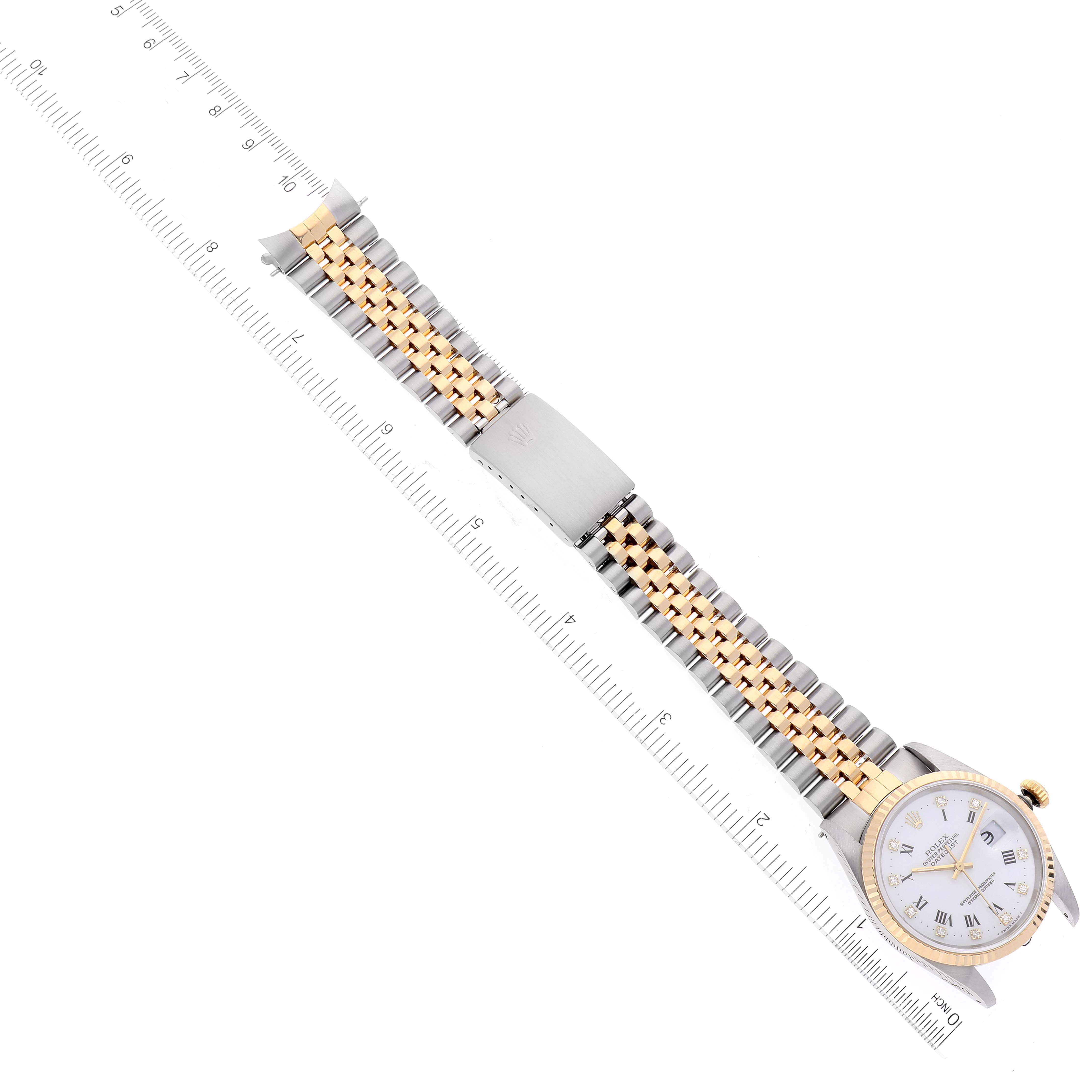 The Rolex Datejust 16233 Men's Steel and Gold (two tone) White Dial 16233 Men's Steel and Gold (two tone) White Dial watch is shown from a top-down angle, displaying the face, bracelet, and clasp, alongside a ruler for scale.