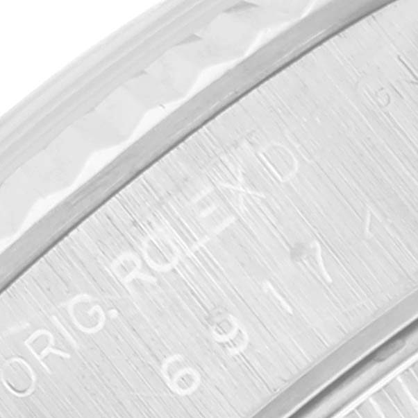 This image shows a close-up of the engravings on the bezel of a Rolex Datejust 69174 Women's Stainless Steel Blue Dial 69174 Women's Stainless Steel Blue Dial watch.