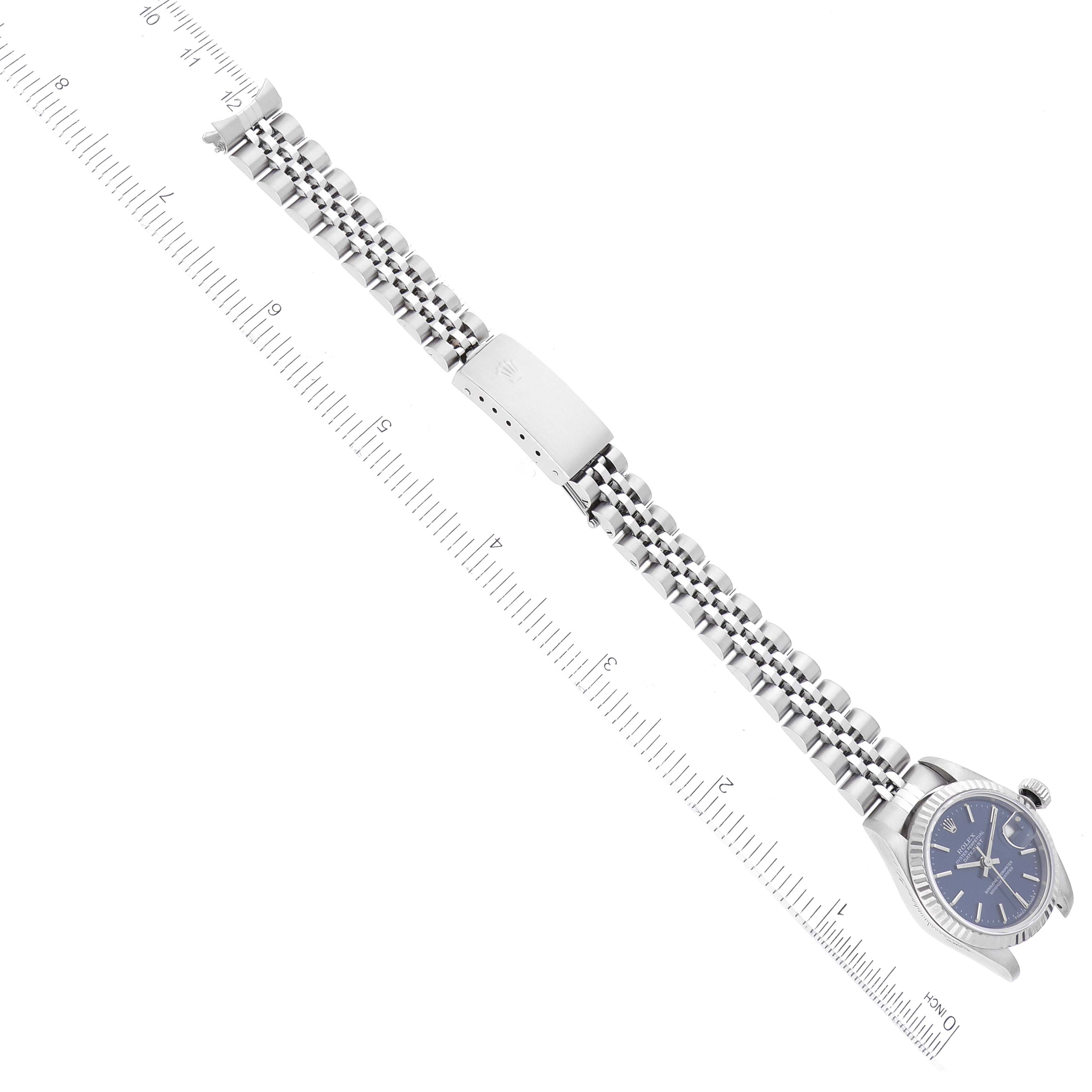 The image shows a Rolex Datejust 69174 Women's Stainless Steel Blue Dial 69174 Women's Stainless Steel Blue Dial watch laid flat with an extended Jubilee bracelet and a ruler for scale.