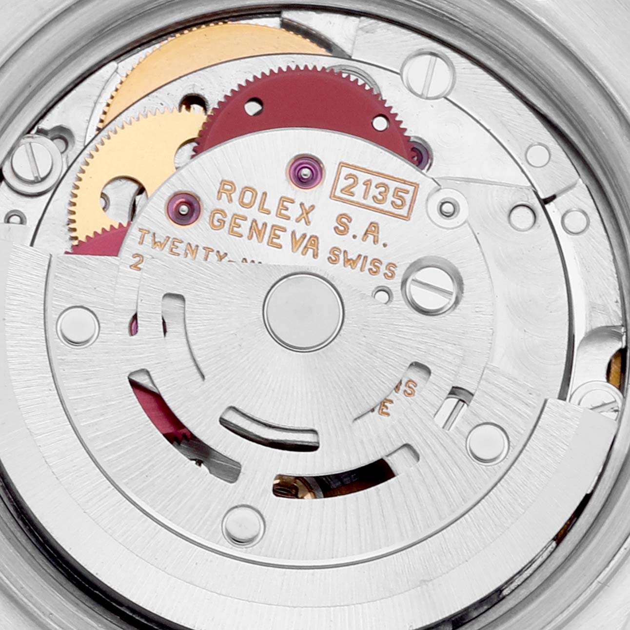 This image shows the internal movement mechanism of a Rolex Datejust 69174 Women's Stainless Steel Blue Dial 69174 Women's Stainless Steel Blue Dial watch, featuring gears and engraved parts.