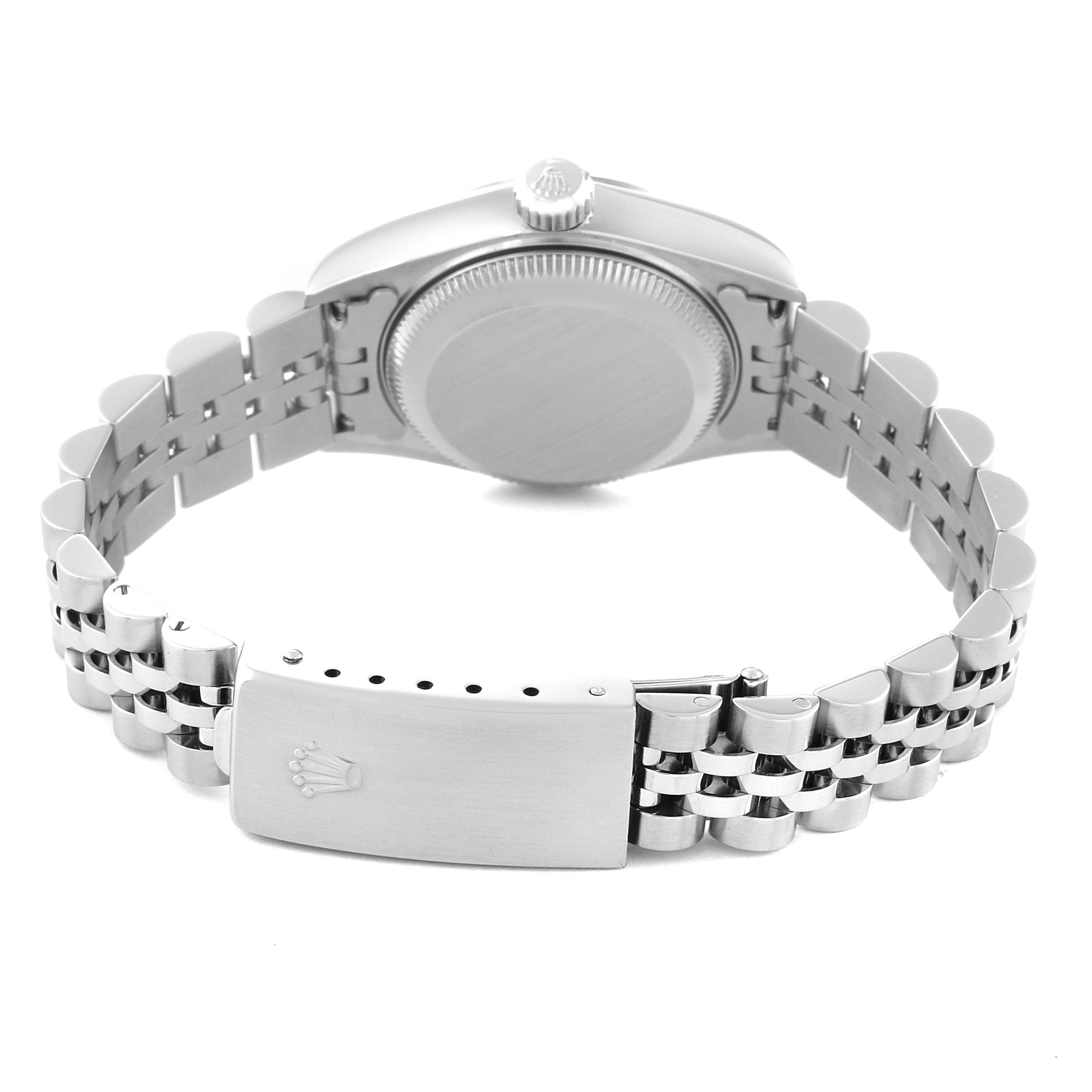 This image shows the back of a Rolex Datejust 79174 Women's Stainless Steel Silver Dial 79174 Women's Stainless Steel Silver Dial watch and its metal bracelet with the clasp open.