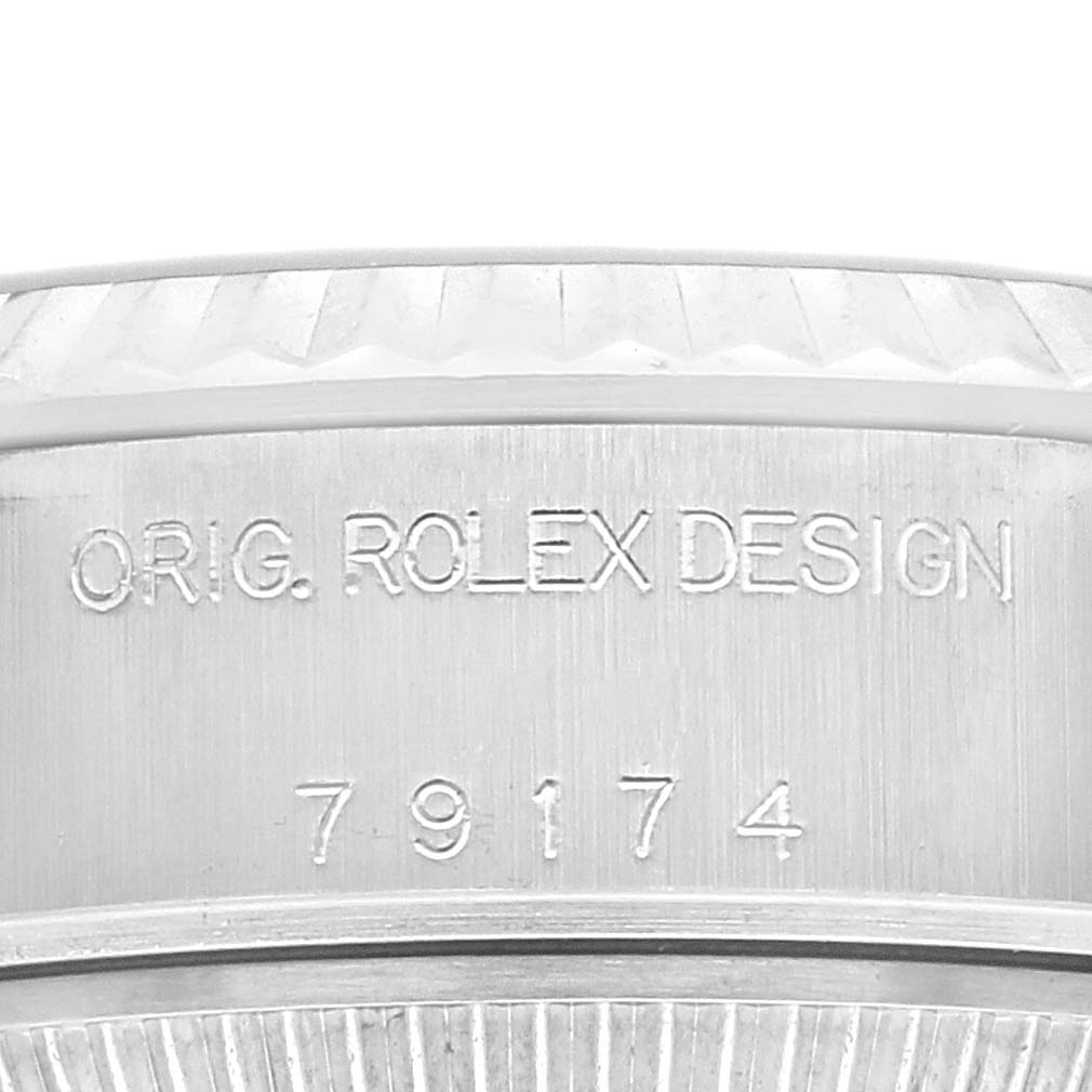 The image shows a close-up angle of the Datejust model by Rolex, focusing on the engraved serial and model information on the case.