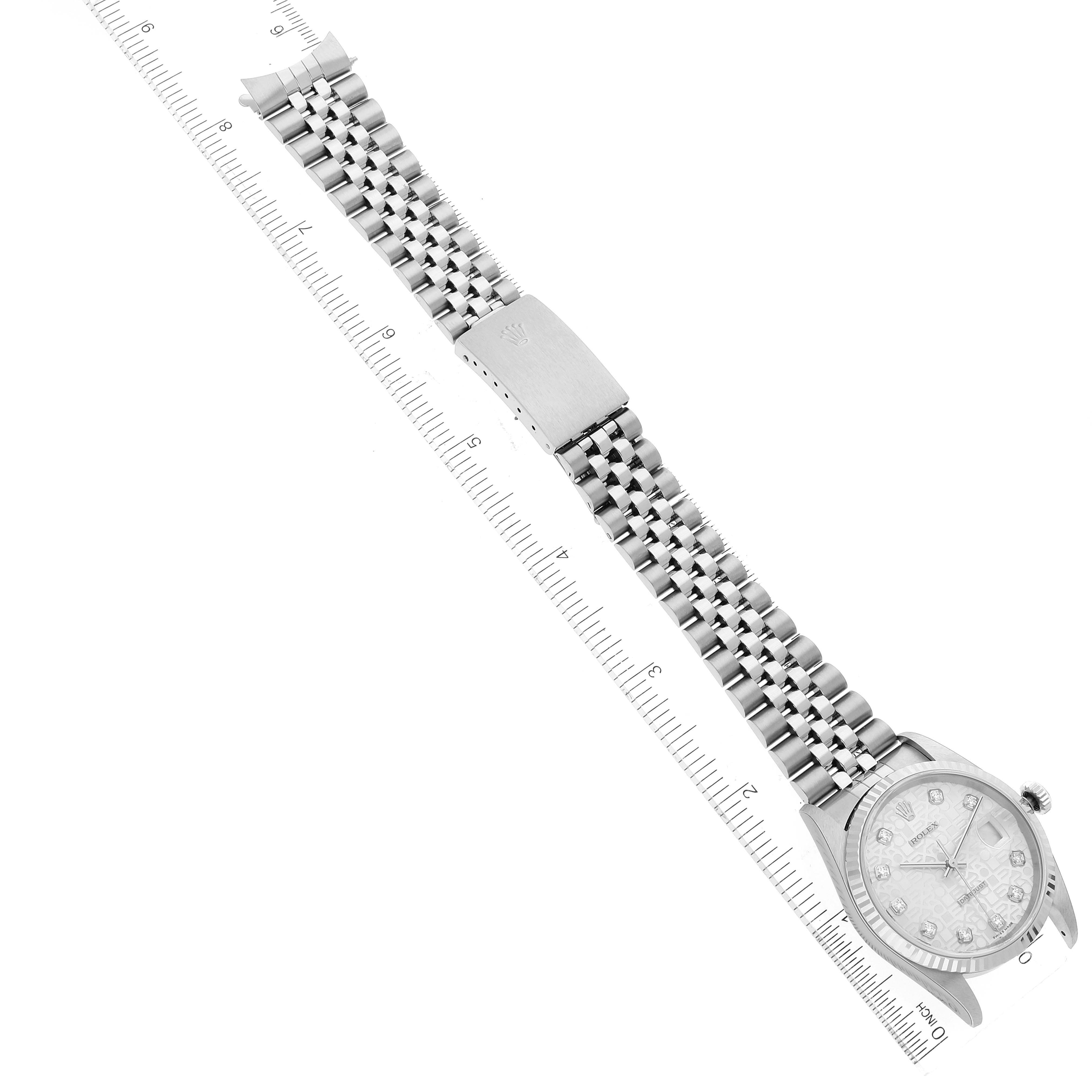 The image shows a top-down view of a Rolex Datejust 16234 Men's Stainless Steel Silver Dial 16234 Men's Stainless Steel Silver Dial watch, focusing on the face, bracelet, and clasp alongside a ruler for scale.
