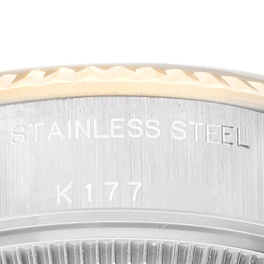 This close-up image shows the inscription and part of the fluted bezel of the Rolex Datejust 79173 Women's Steel and Gold (two tone) Black Dial 79173 Women's Steel and Gold (two tone) Black Dial model watch.