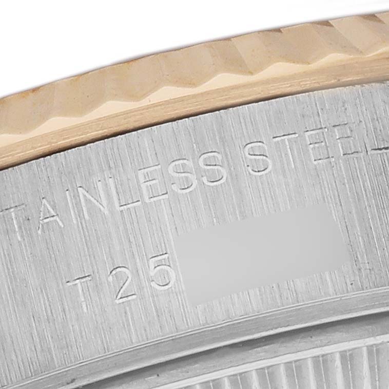 This close-up image shows the engraving on the stainless steel case back near the fluted bezel of a Rolex Datejust 69173G Women's Steel and Gold (two tone) Green Dial 69173G Women's Steel and Gold (two tone) Green Dial watch.