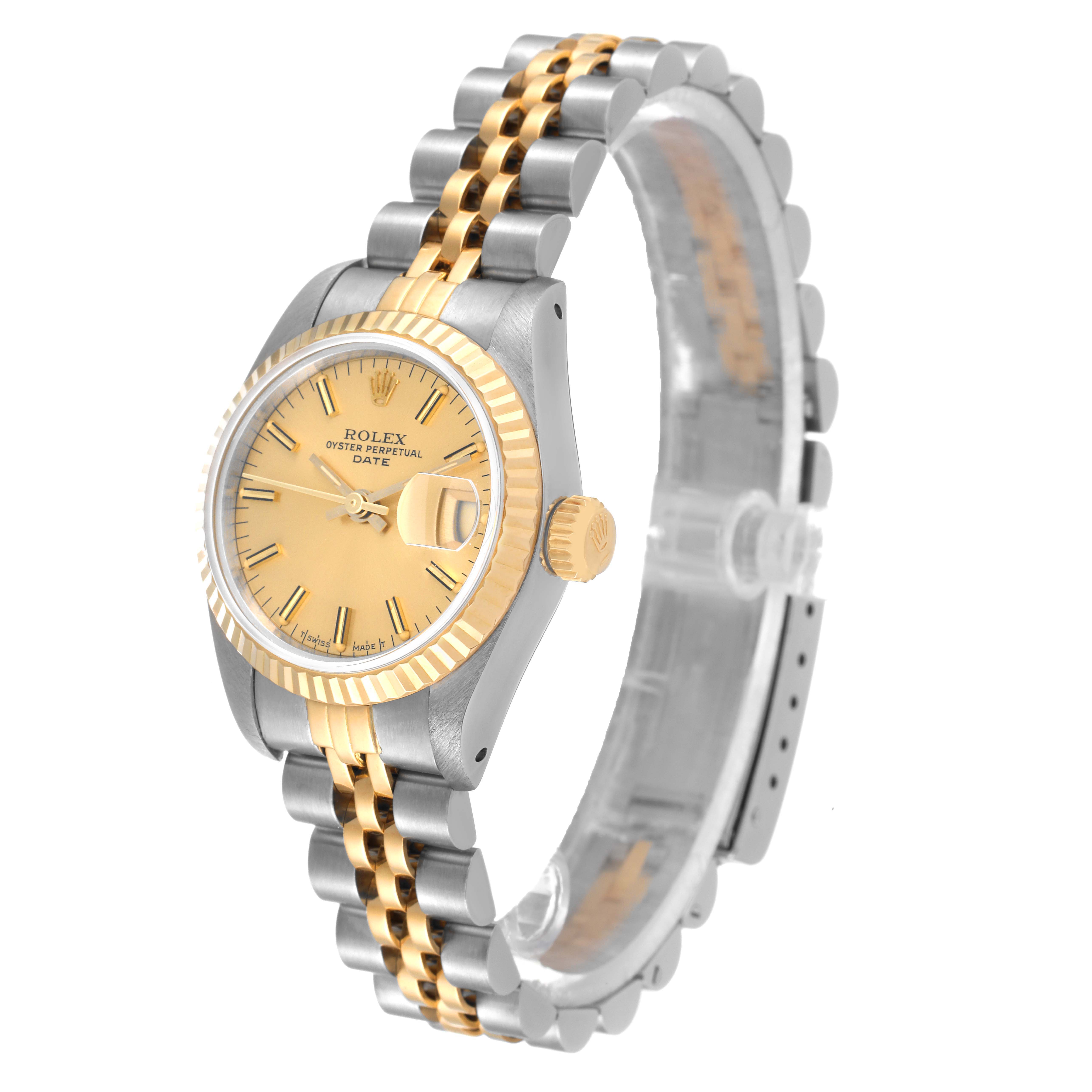The image shows a side angle of a Rolex Datejust 69173 Women
s Steel and Gold (two tone) Champagne Dial 69173 Women
s Steel and Gold (two tone) Champagne Dial watch, highlighting its bezel, crown, face, and bracelet.