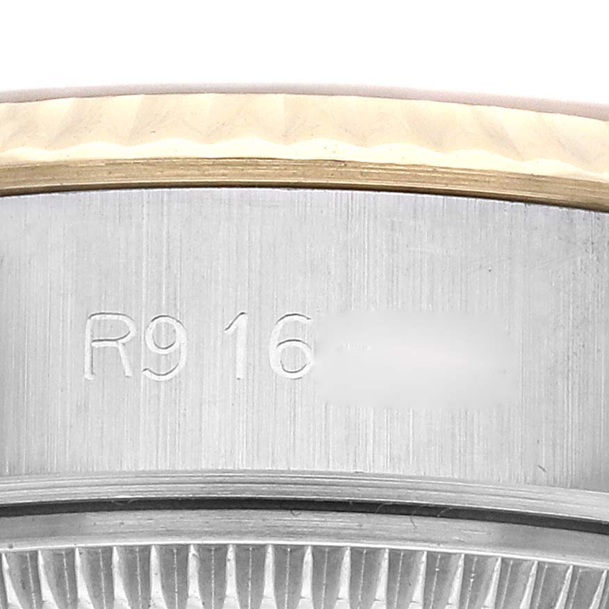 This close-up image shows the serial number engraved on the side of a Rolex Datejust 69173 Women's Steel and Gold (two tone) Champagne Dial 69173 Women's Steel and Gold (two tone) Champagne Dial watch near the bezel.