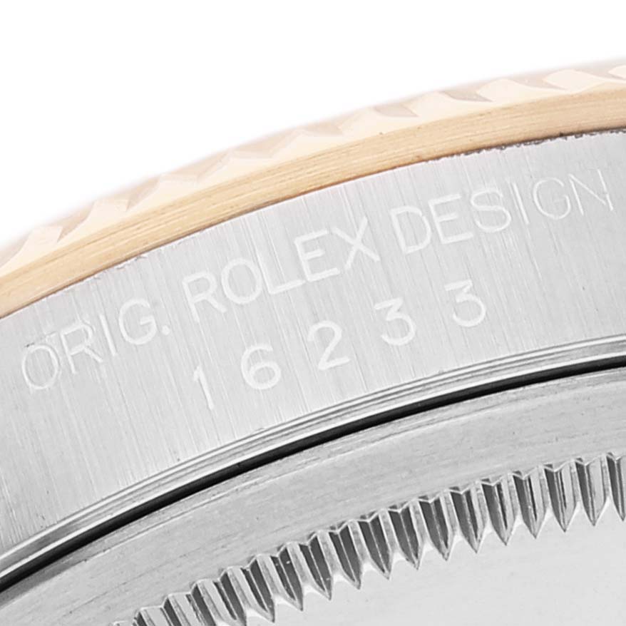 This image shows the edge and side of the bezel with the engraved model number on a Rolex Datejust 16233 Men's Steel and Gold (two tone) Mother of Pearl Dial 16233 Men's Steel and Gold (two tone) Mother of Pearl Dial watch.