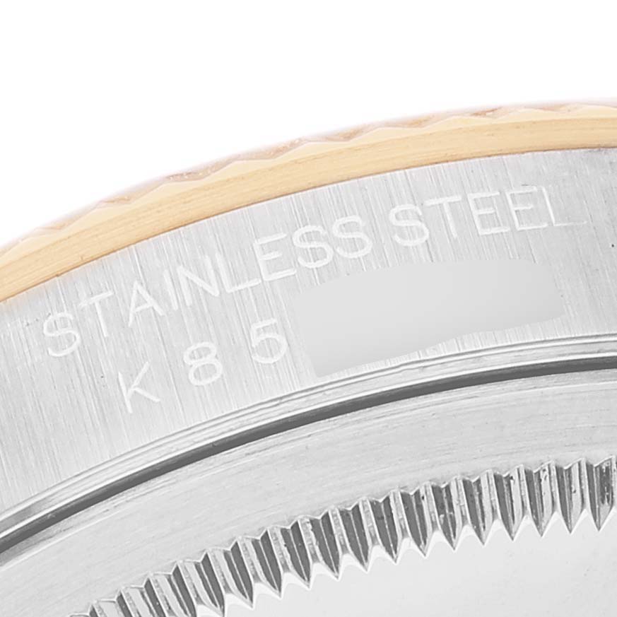 The image shows a close-up of the side edge and part of the fluted bezel of a Rolex Datejust 16233 Men's Steel and Gold (two tone) Mother of Pearl Dial 16233 Men's Steel and Gold (two tone) Mother of Pearl Dial watch.