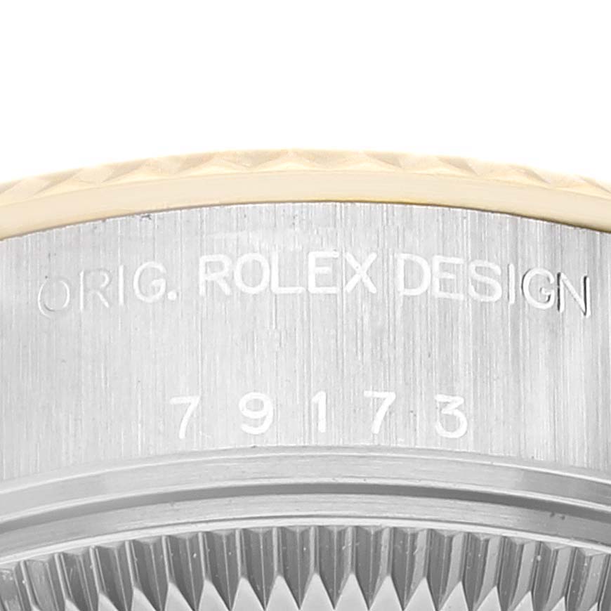 This image shows a close-up of the side of a Rolex Datejust 79173 Women's Steel and Gold (two tone) White Dial 79173 Women's Steel and Gold (two tone) White Dial model, displaying the "ORIG. ROLEX DESIGN" engraving and part of the bezel.