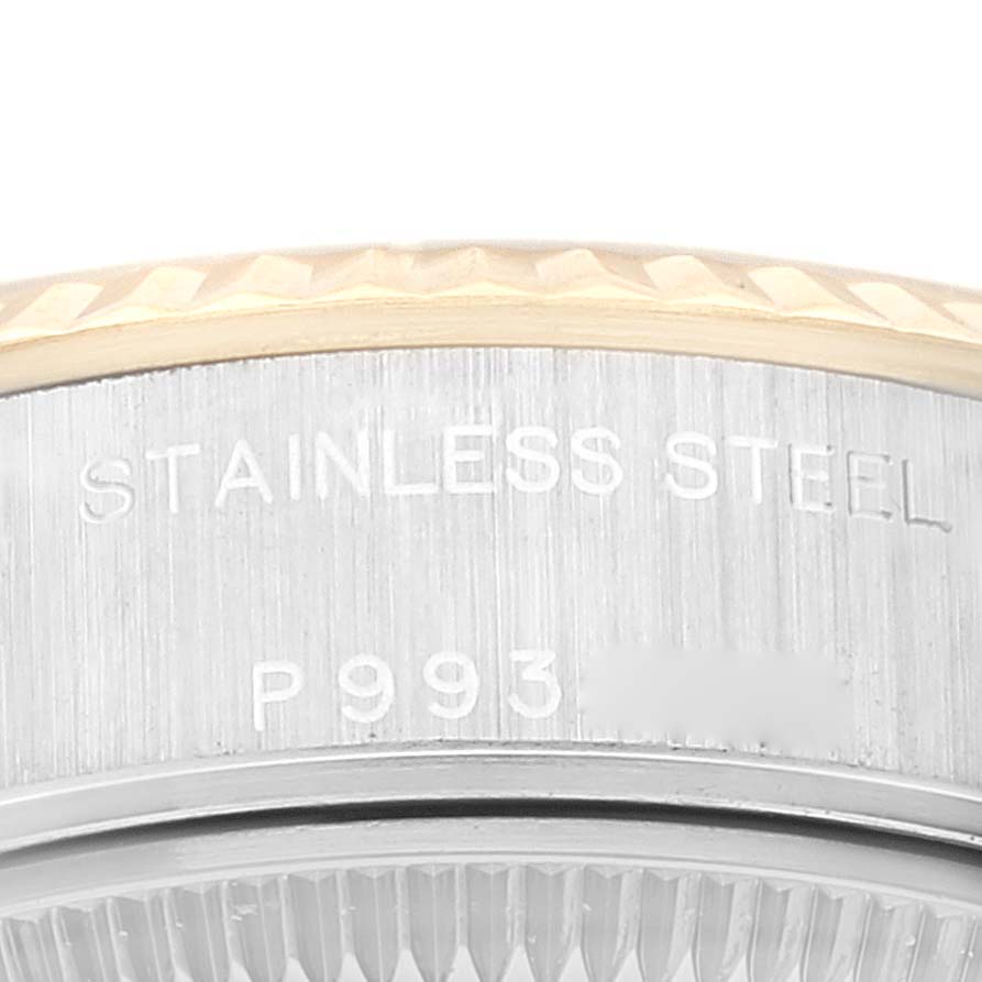 This close-up image of a Rolex Datejust 79173 Women's Steel and Gold (two tone) White Dial 79173 Women's Steel and Gold (two tone) White Dial watch shows part of the stainless steel case and the edge of the fluted bezel.