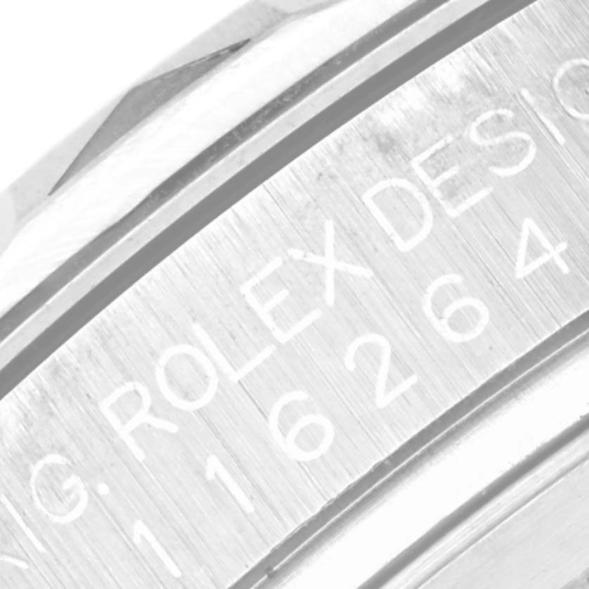 This close-up image shows the engraved side of the bezel and part of the case of a Rolex Turn-o-Graph 116264 Men's Stainless Steel Black Dial 116264 Men's Stainless Steel Black Dial watch.