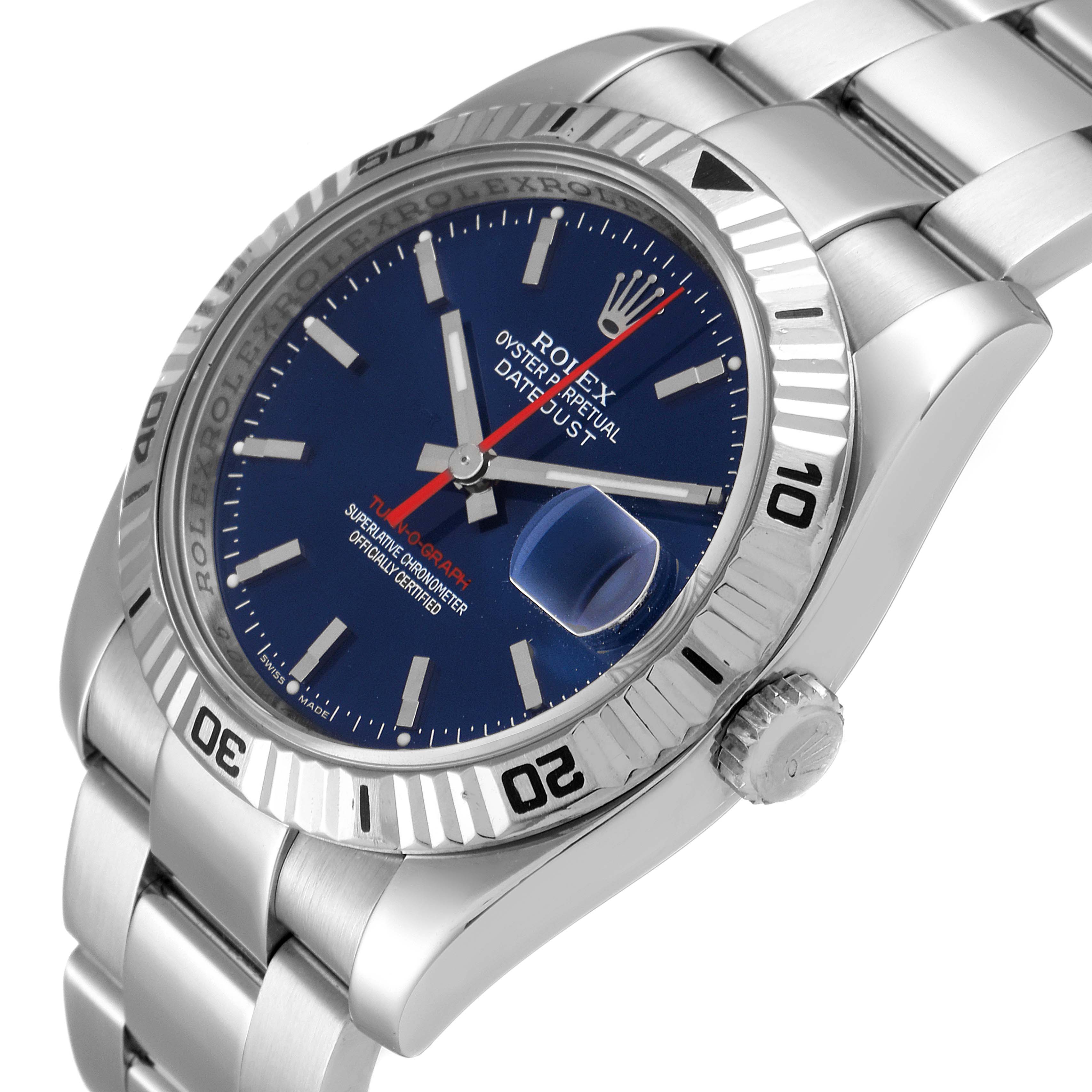 The image shows a Rolex Turn-o-Graph 116264 Men
s Stainless Steel Blue Dial 116264 Men
s Stainless Steel Blue Dial watch at an angle displaying its blue dial, fluted bezel, date magnifier, and stainless steel bracelet.
