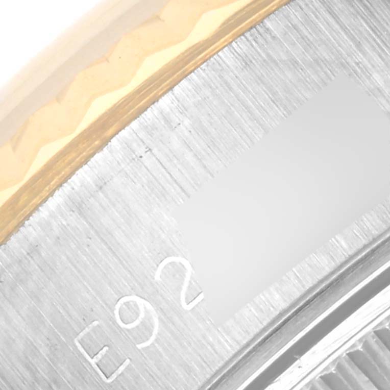 The image shows a close-up of the edge of the case back of a Rolex Datejust 69173 Women's Steel and Gold (two tone) White Dial 69173 Women's Steel and Gold (two tone) White Dial watch, displaying part of the serial number and bezel.