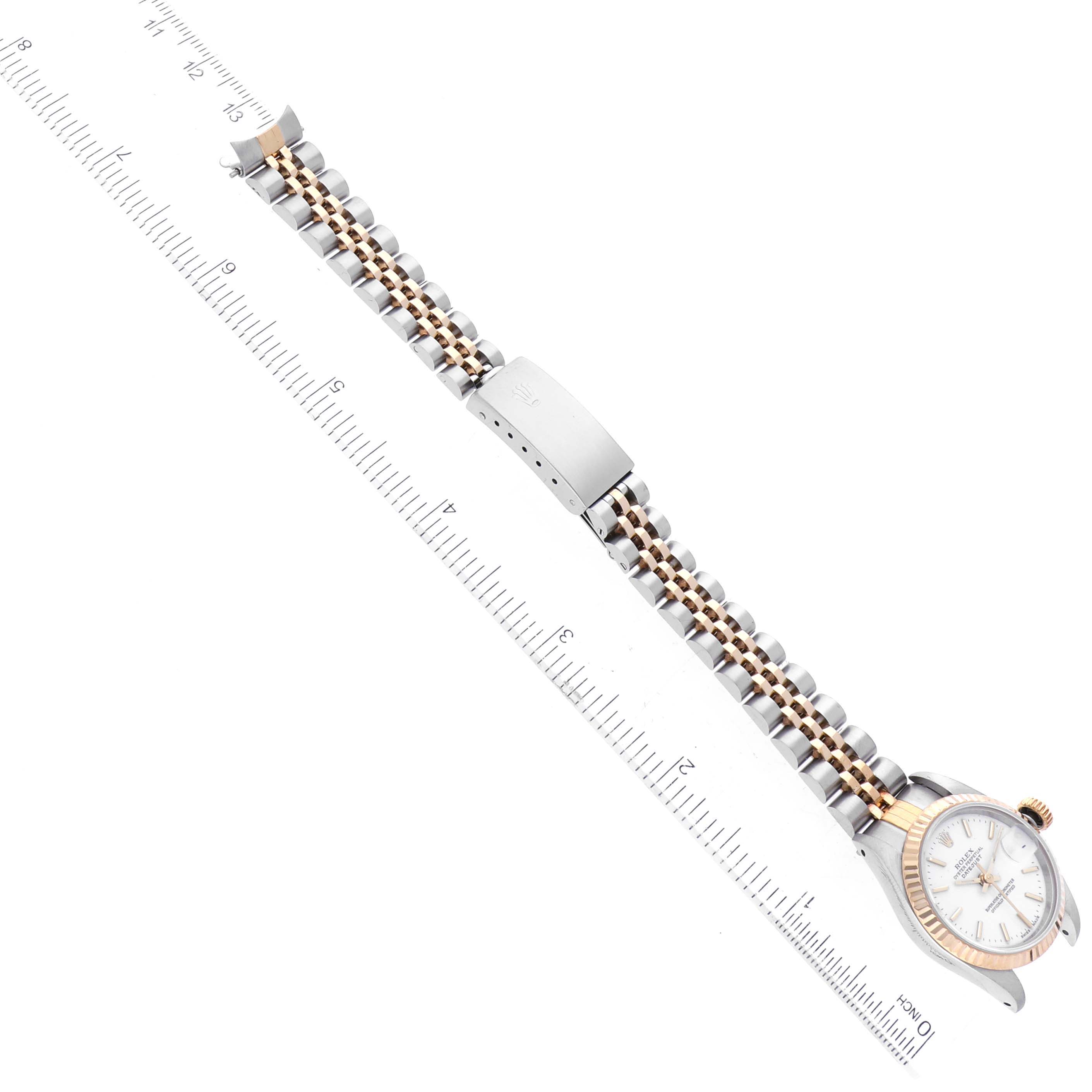 The image shows the Rolex Datejust 69173 Women's Steel and Gold (two tone) White Dial 69173 Women's Steel and Gold (two tone) White Dial model watch positioned flat with its bracelet extended alongside a ruler for measurement.