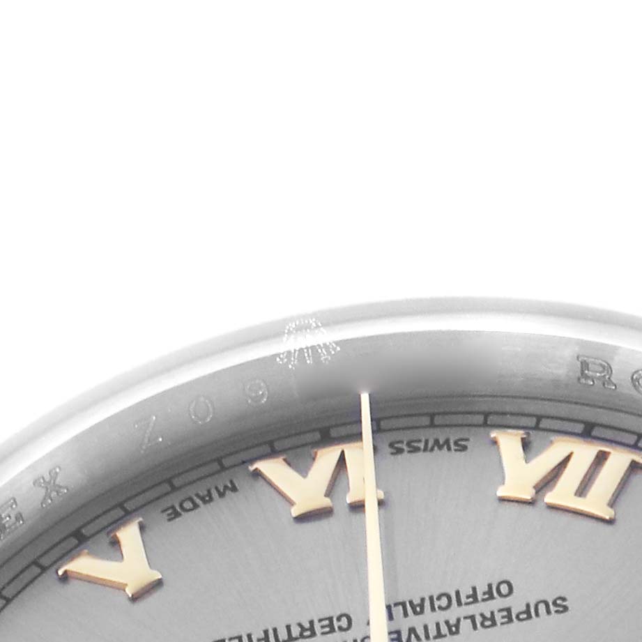 The image shows a close-up of the Rolex Datejust 179163 Women
s Steel and Gold (two tone) Grey Dial 179163 Women
s Steel and Gold (two tone) Grey Dial
s dial and bezel, highlighting the Roman numerals and text details.