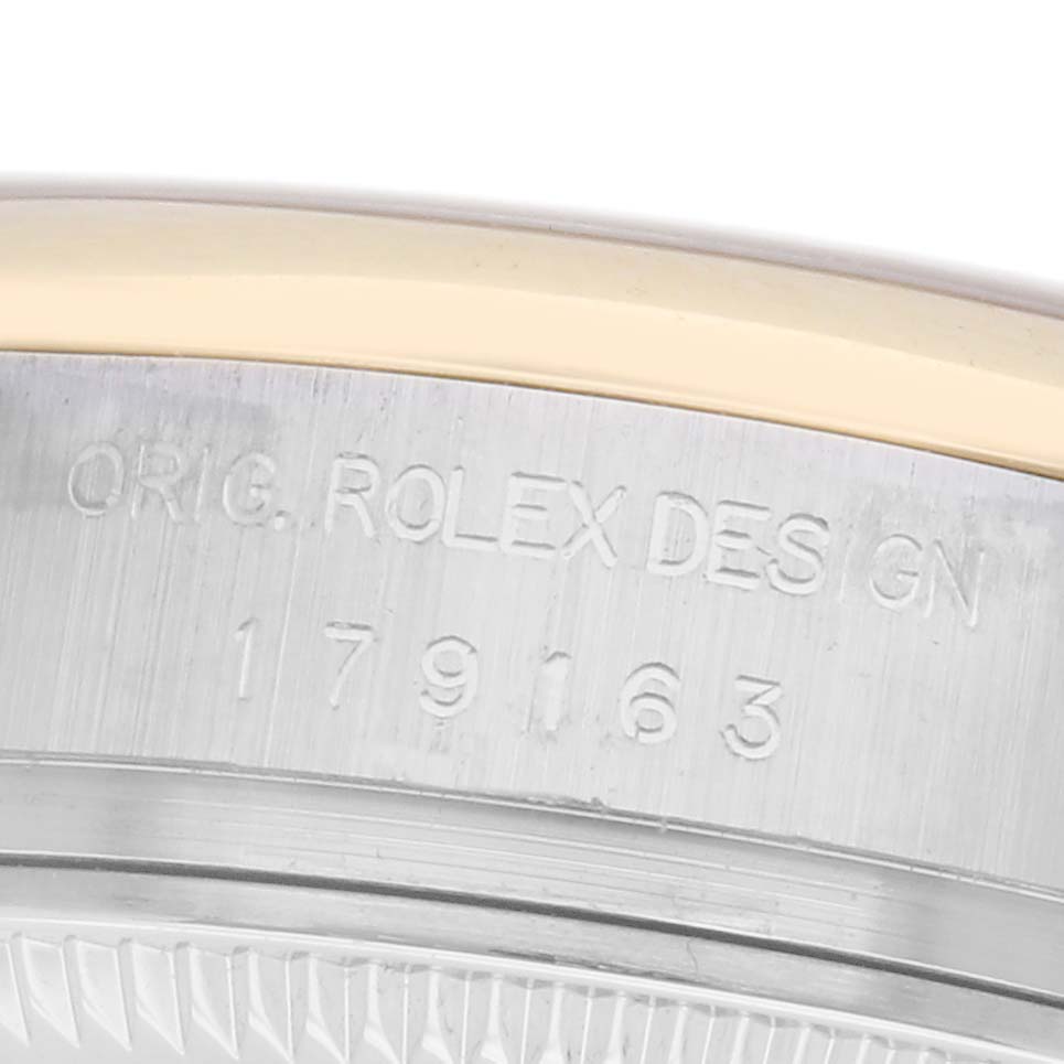 The image shows a close-up of the side of a Rolex Datejust 179163 Women
s Steel and Gold (two tone) Grey Dial 179163 Women
s Steel and Gold (two tone) Grey Dial watch, focusing on the engraved model number and "ORIG. ROLEX DESIGN."