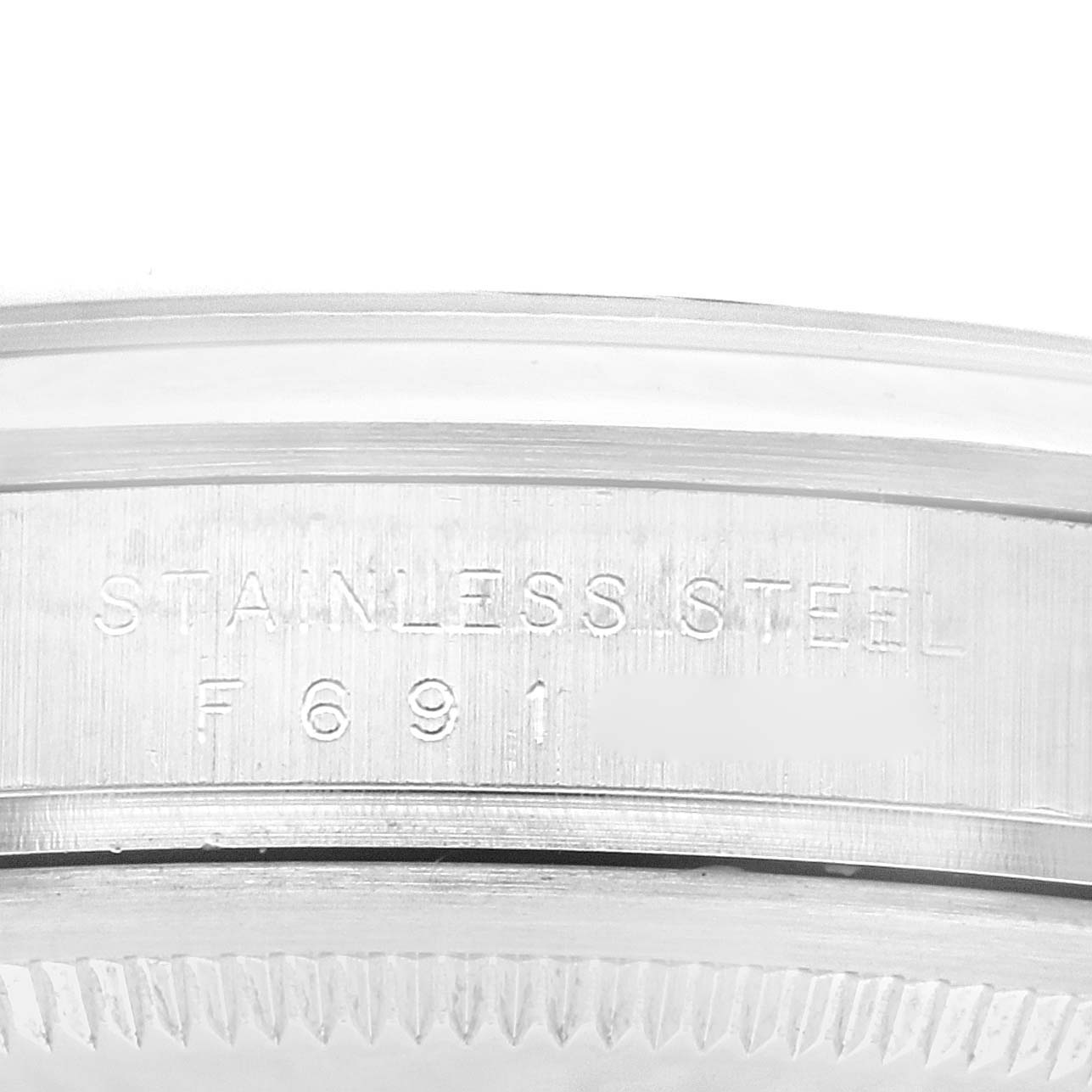 This image shows the side of a Rolex Explorer 114270 Men
s Stainless Steel Black Dial 114270 Men
s Stainless Steel Black Dial watch, detailing the stainless steel marking and part of the bezel.