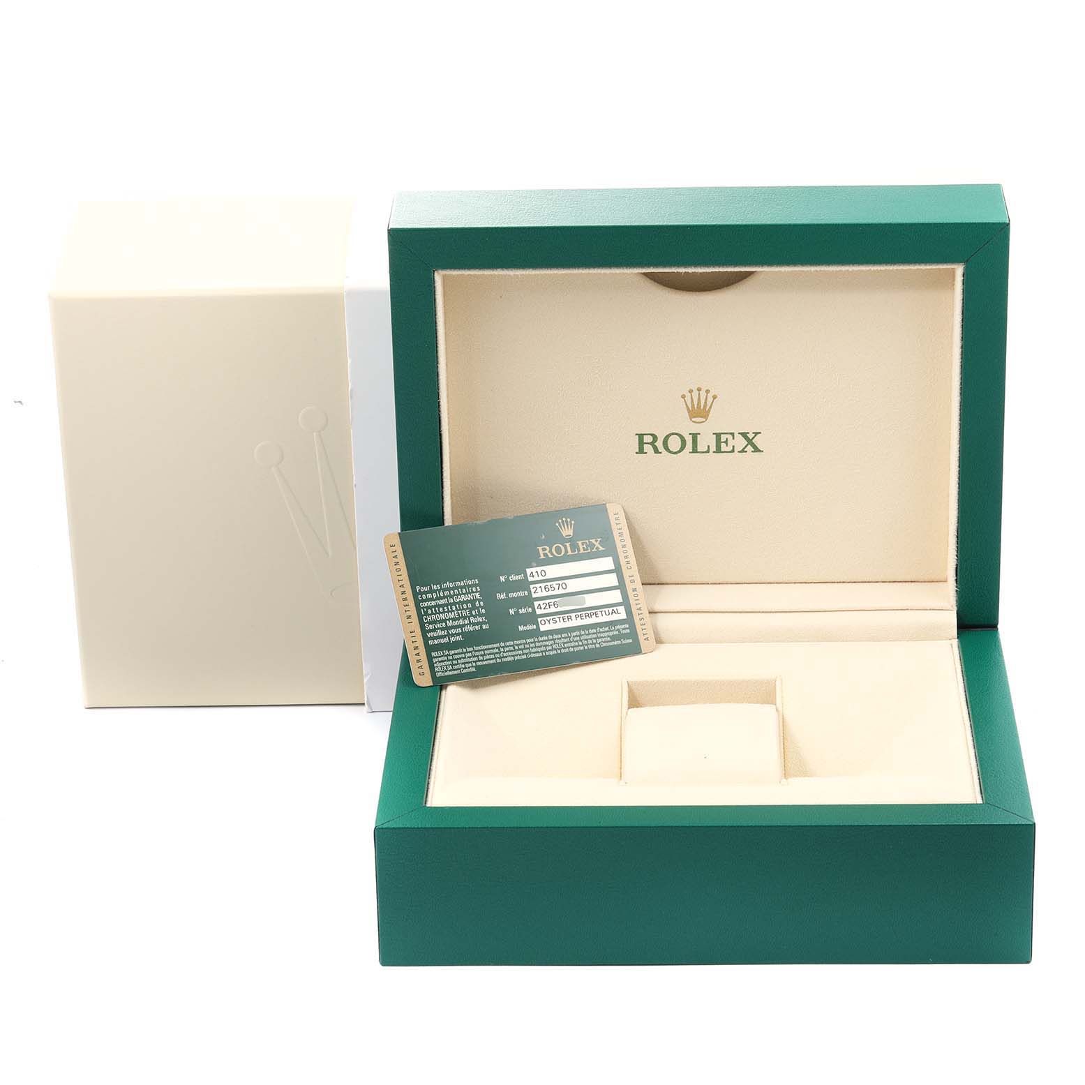 This image shows an opened Rolex Explorer 216570 Men's Stainless Steel Black Dial 216570 Men's Stainless Steel Black Dial watch box with warranty card and outer packaging.