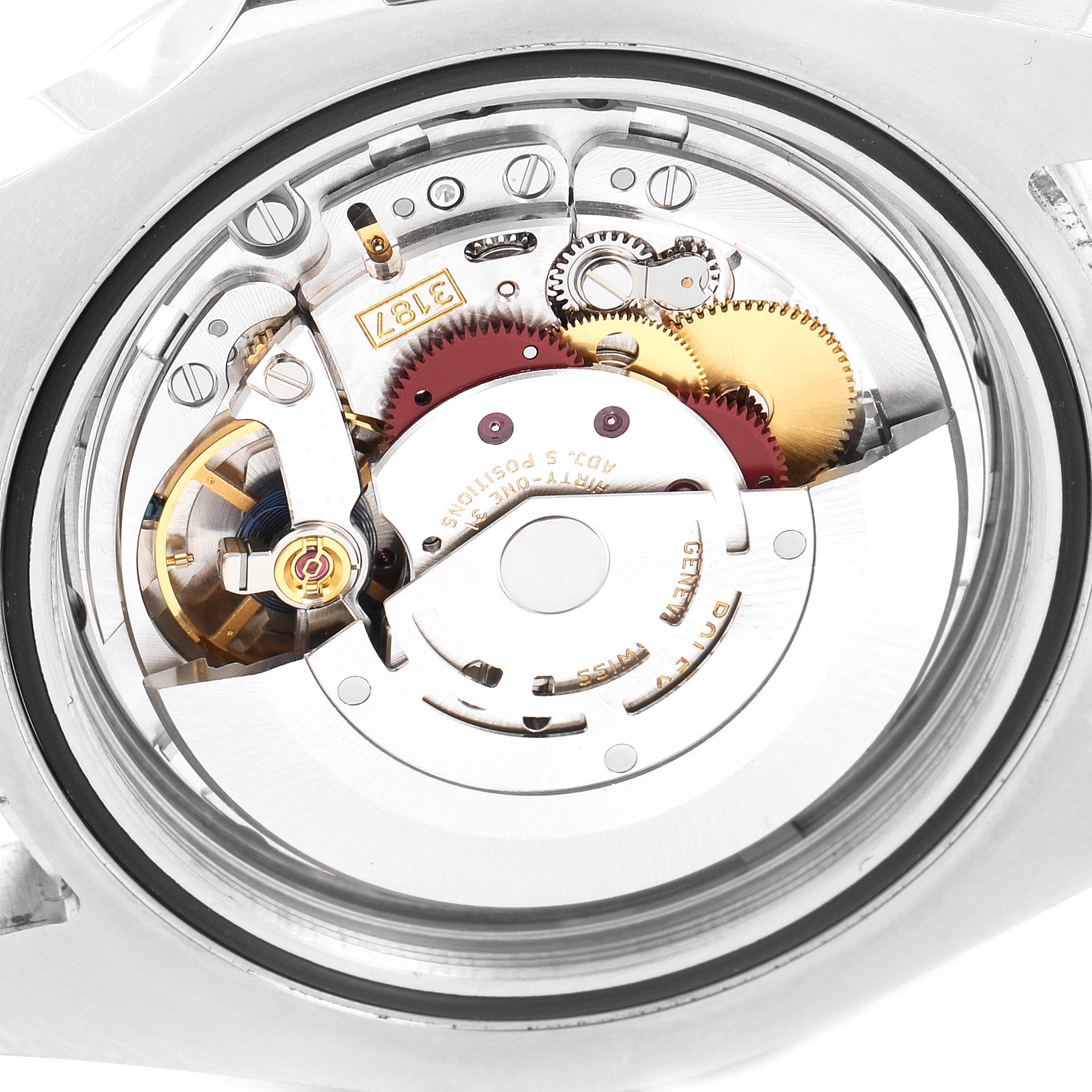 This close-up view of the Rolex Explorer 216570 Men's Stainless Steel Black Dial 216570 Men's Stainless Steel Black Dial watch shows the intricate inner mechanical movement parts.