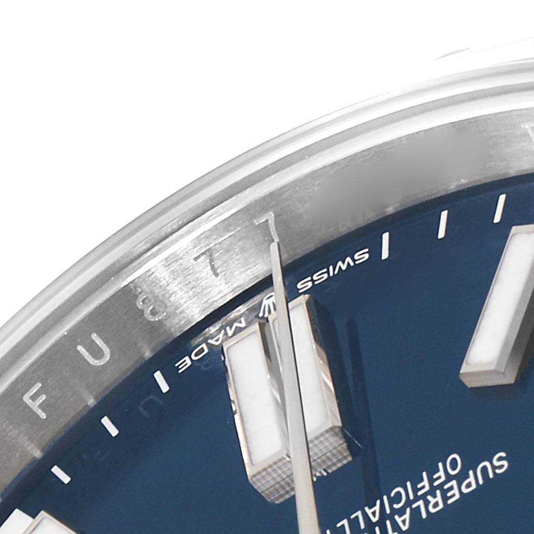 This close-up angle shows parts of the dial, hands, and bezel of the Rolex Oyster Perpetual 124300 Men's Stainless Steel Blue Dial 124300 Men's Stainless Steel Blue Dial watch.