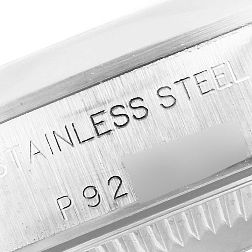 This close-up image shows the stainless steel engraving on the case back of a Rolex Oyster Perpetual 76080 Women's Stainless Steel Black Dial 76080 Women's Stainless Steel Black Dial watch.