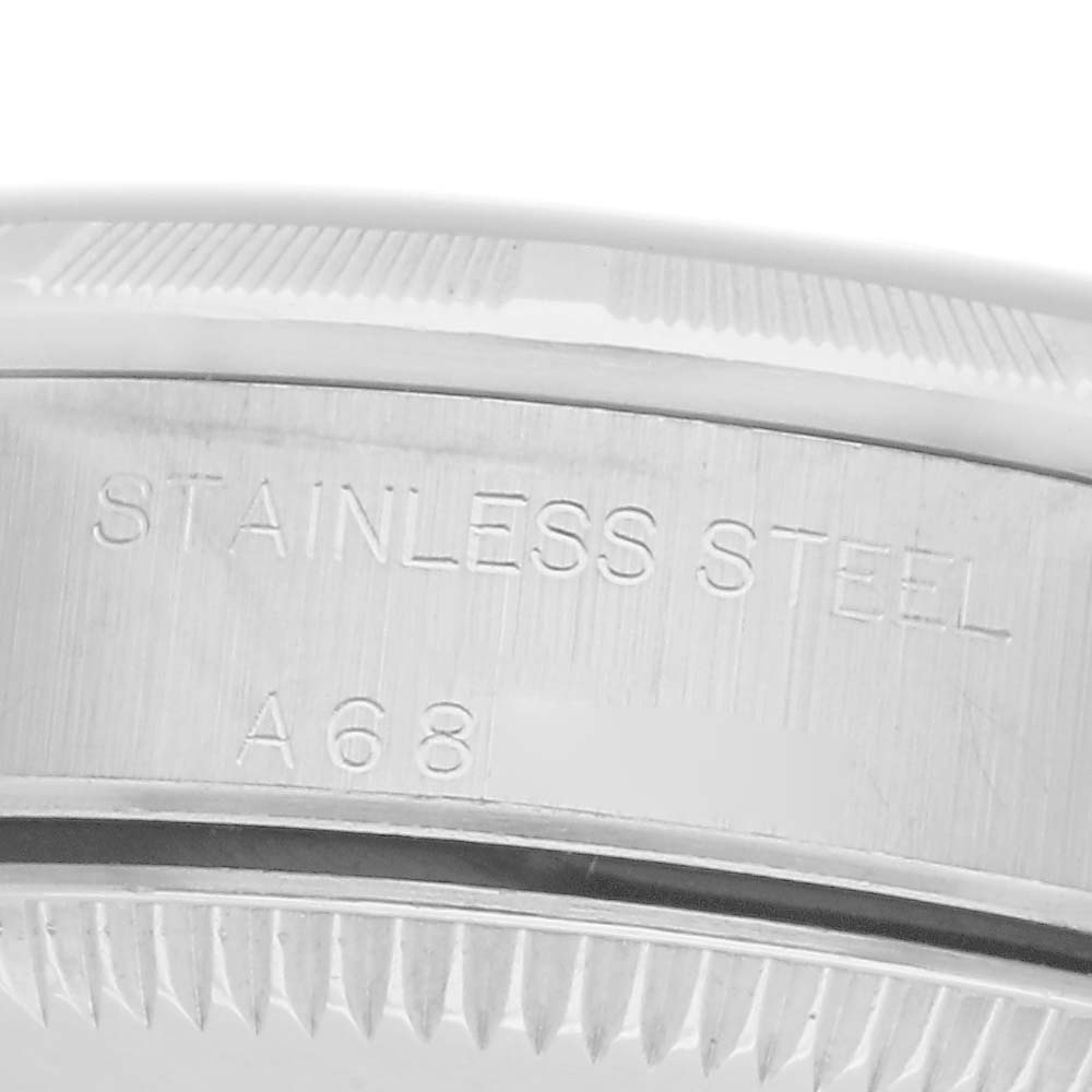 The image shows a close-up of the side of a Rolex Oyster Perpetual 76030 Women's Stainless Steel Pink Dial 76030 Women's Stainless Steel Pink Dial watch, highlighting the stainless steel material and bezel engravings.