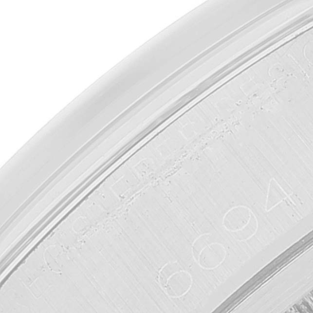 This image shows a close-up of the edge of the bezel with engraved markings on a Vintage Collection Rolex watch.