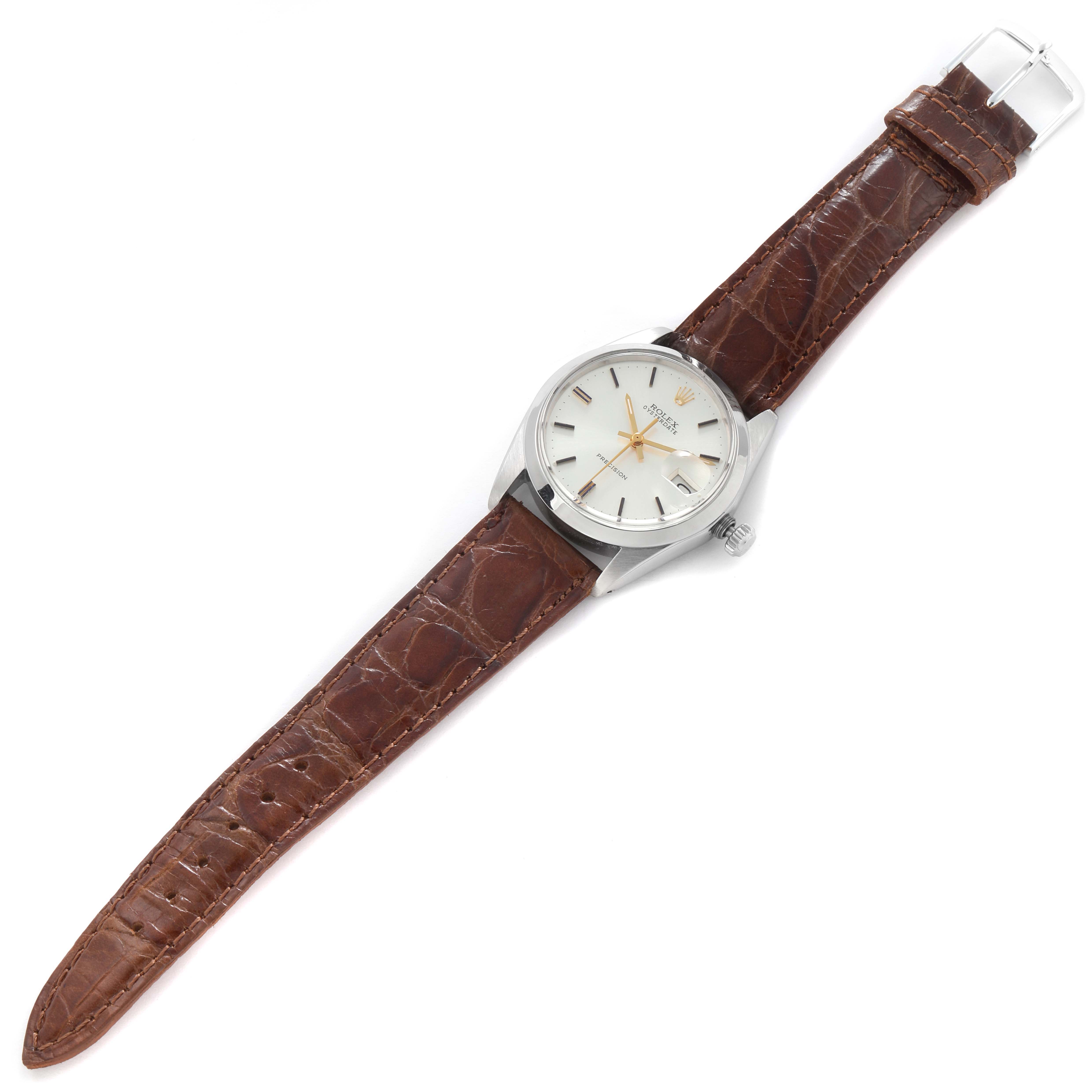 The Rolex Vintage Collection 6694 Men
s Stainless Steel Silver Dial 6694 Men
s Stainless Steel Silver Dial watch is shown from a top-down angle, featuring a brown leather strap and a silver case.