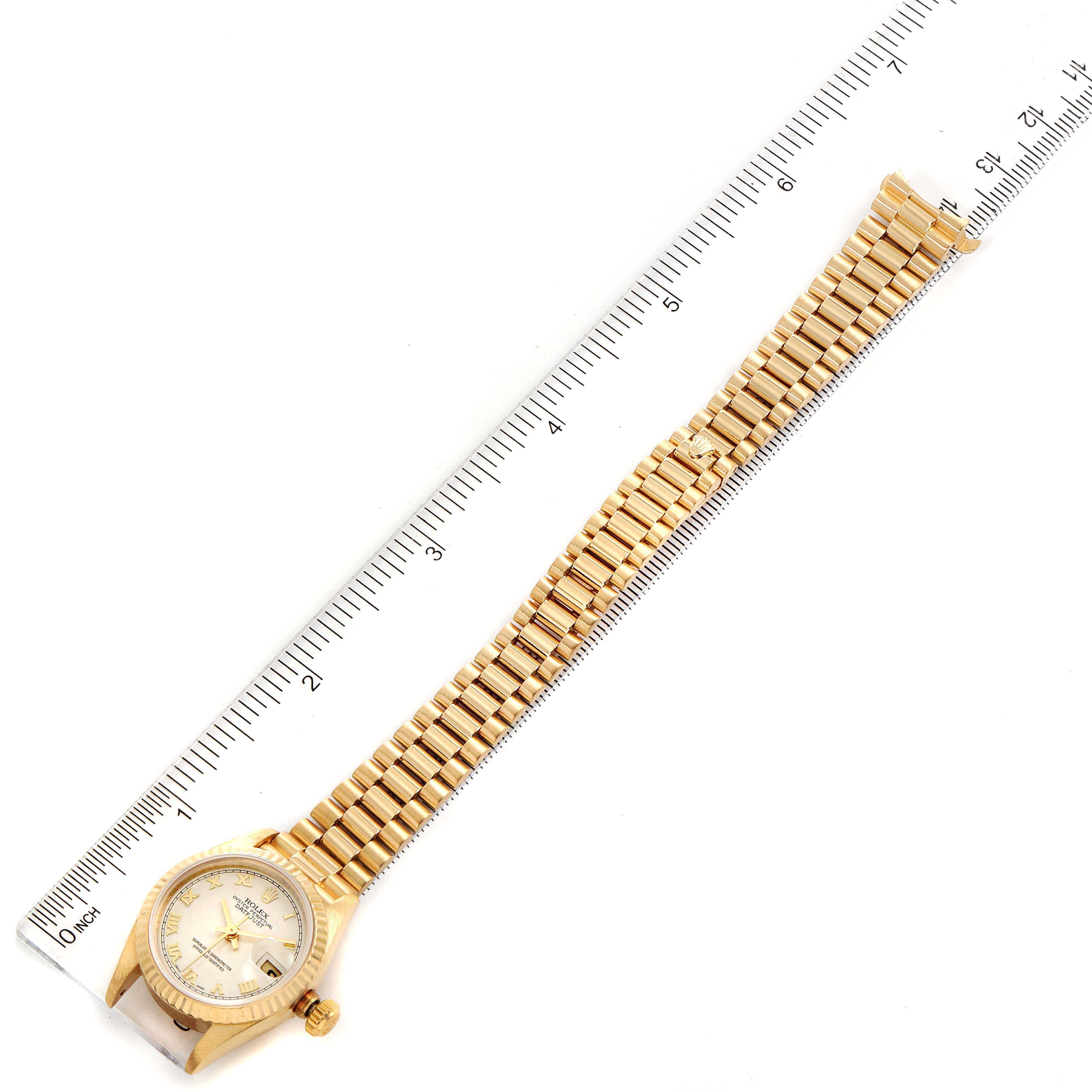 The image shows a Rolex President 69178 Women's Yellow Gold Beige Dial 69178 Women's Yellow Gold Beige Dial model watch laid flat with its band next to a ruler for scale.