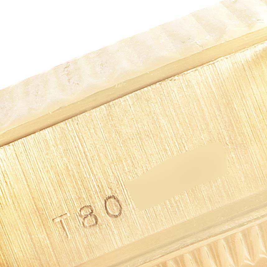 The image shows a close-up of the side of the bezel and case of a Rolex President 69178 Women's Yellow Gold Beige Dial 69178 Women's Yellow Gold Beige Dial model watch with markings.