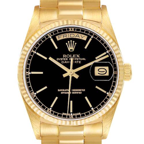 The image shows a front view of the Rolex President model watch, highlighting the black dial, day-date display, and gold bracelet.