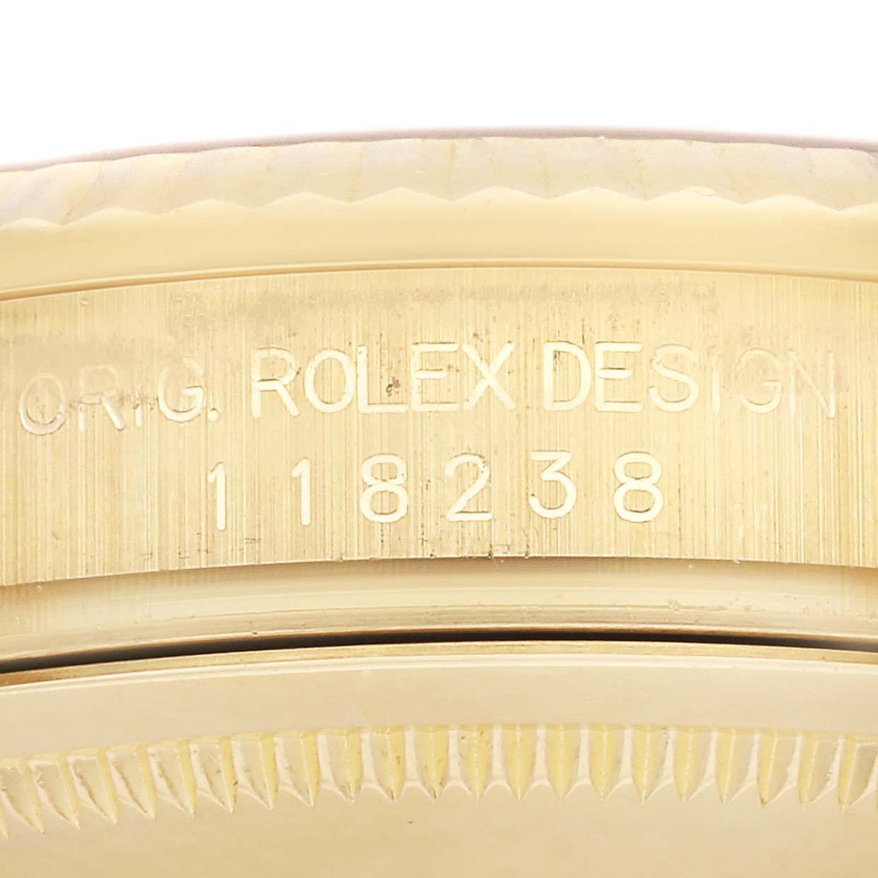 This image shows a close-up of the engraved serial number and design code on the side of a Rolex President 118238 Men
s Yellow Gold Champagne Dial 118238 Men
s Yellow Gold Champagne Dial model watch case.
