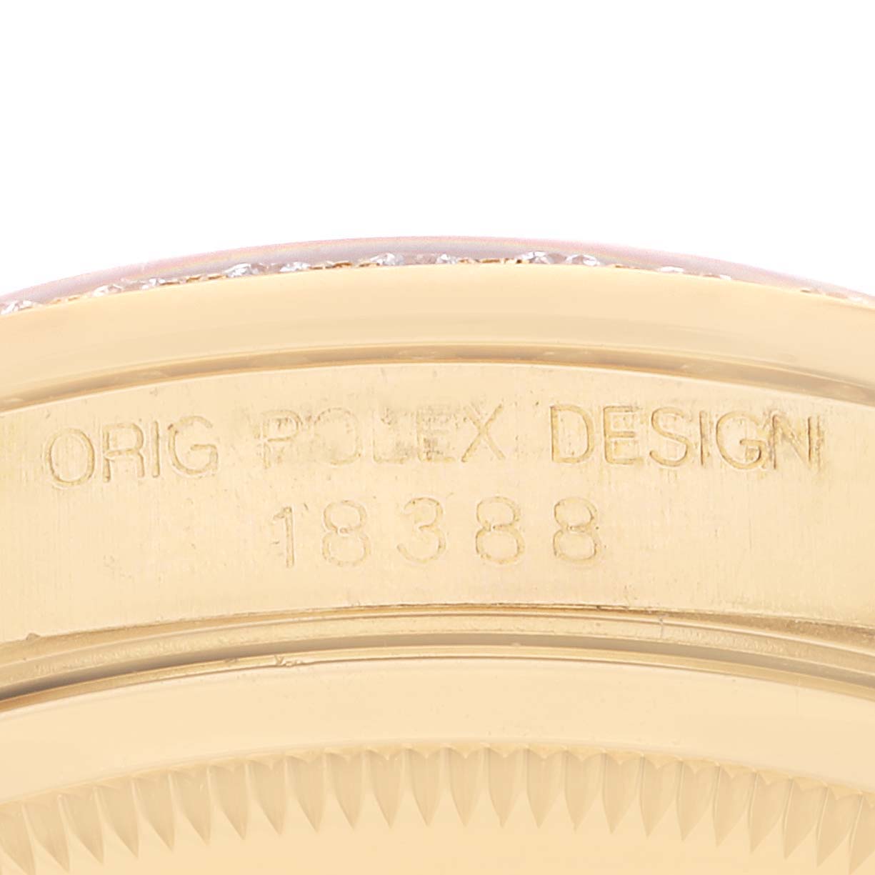 This image shows a close-up angle of the side of the Rolex President 18388 Men
s Yellow Gold Champagne Dial 18388 Men
s Yellow Gold Champagne Dial model watch, focusing on the engraved serial number and "ORIG ROLEX DESIGN."