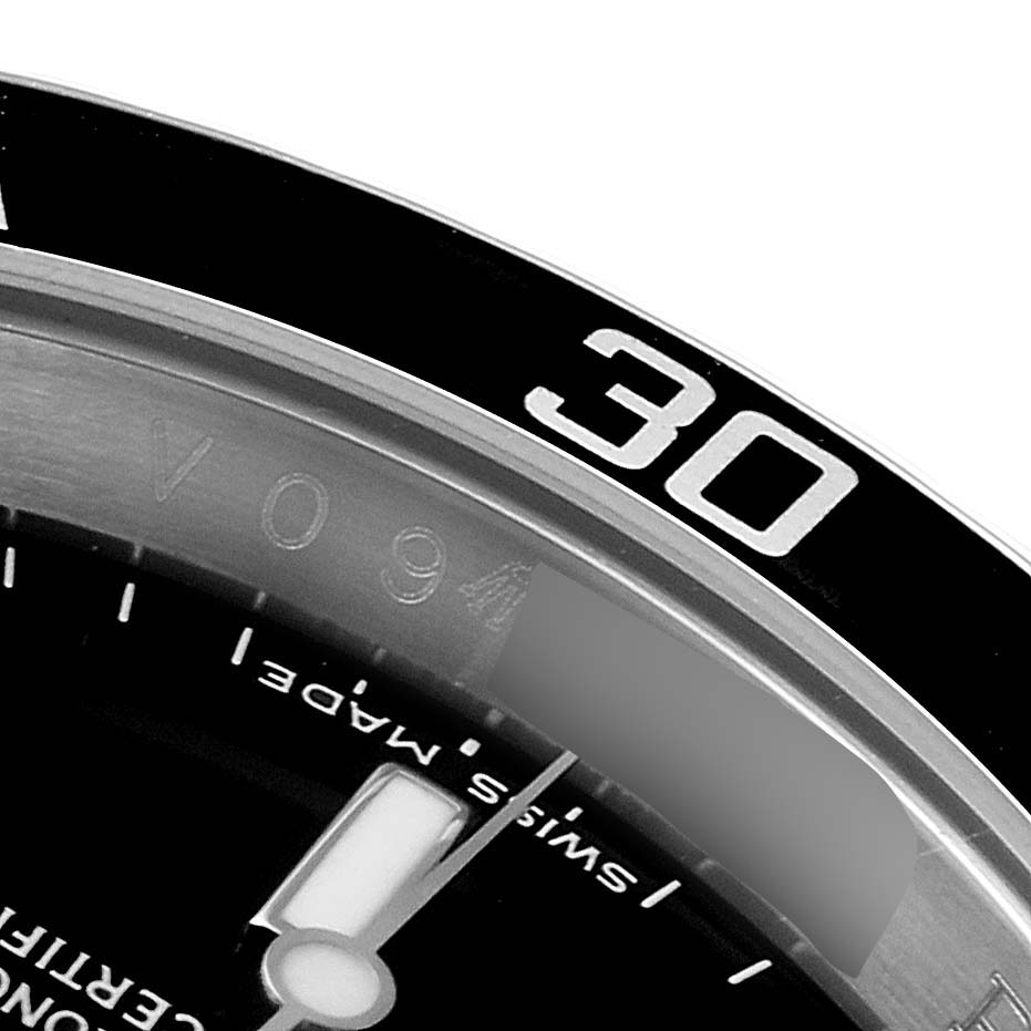 The image shows a close-up of the bezel and part of the dial of a Rolex Submariner 16610 Men
s Stainless Steel Black Dial 16610 Men
s Stainless Steel Black Dial watch, focusing on the 30-minute mark.