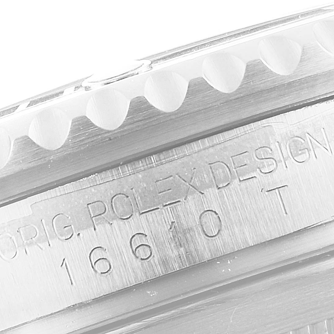 This close-up image of the Rolex Submariner 16610 Men
s Stainless Steel Black Dial 16610 Men
s Stainless Steel Black Dial shows the side view with engraving on the watch case.