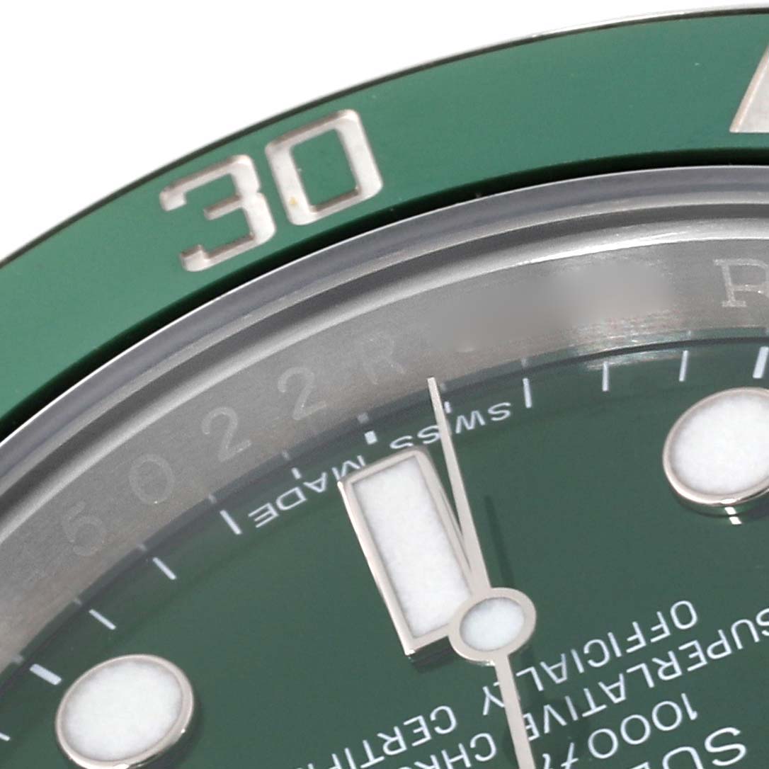 This close-up shows the bezel, dial, and part of the minute hand of a Rolex Submariner 116610LV Men's Stainless Steel Green Dial 116610LV Men's Stainless Steel Green Dial watch model.