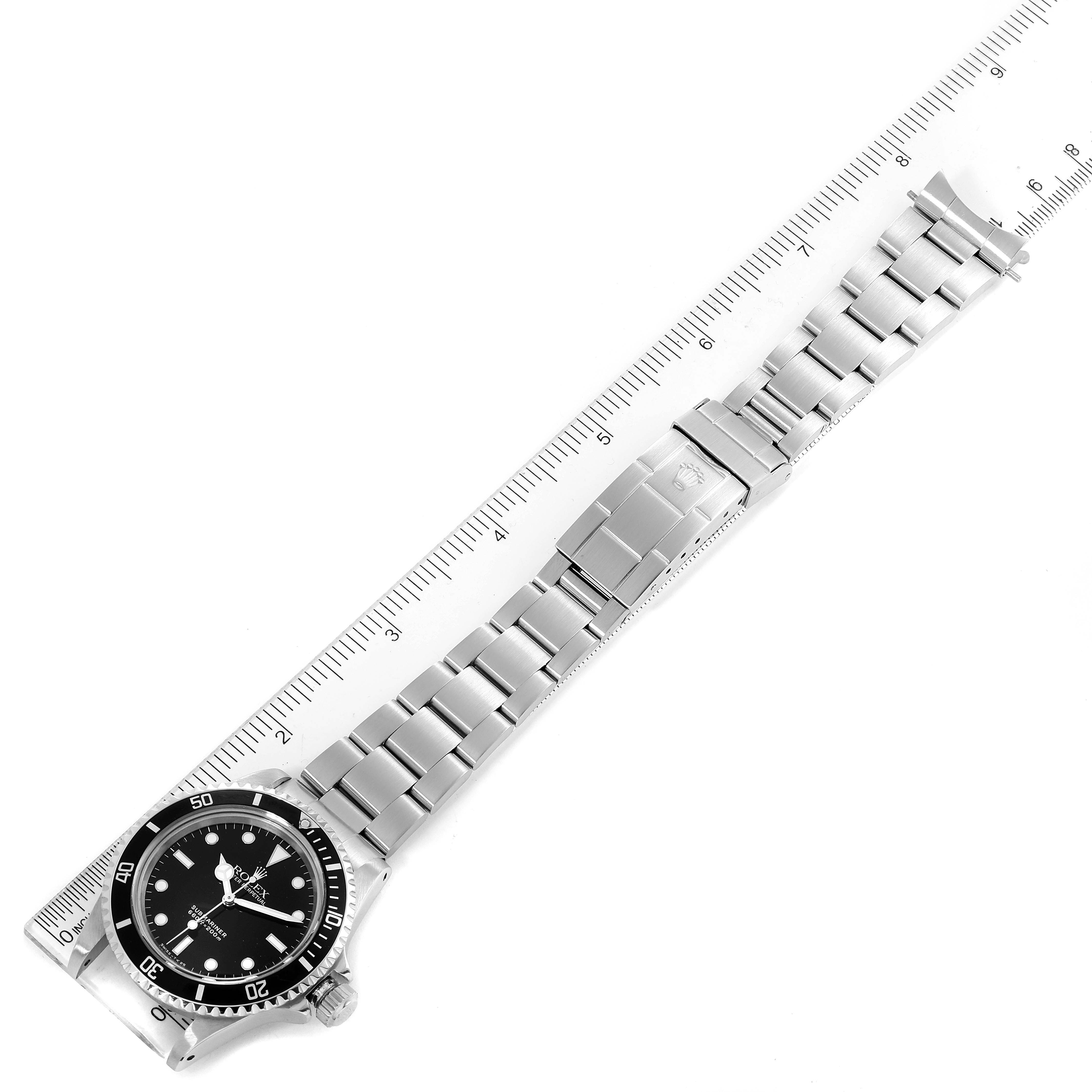 The image shows a Vintage Collection Rolex watch laid flat, displaying the face, bezel, and entire bracelet next to a ruler.