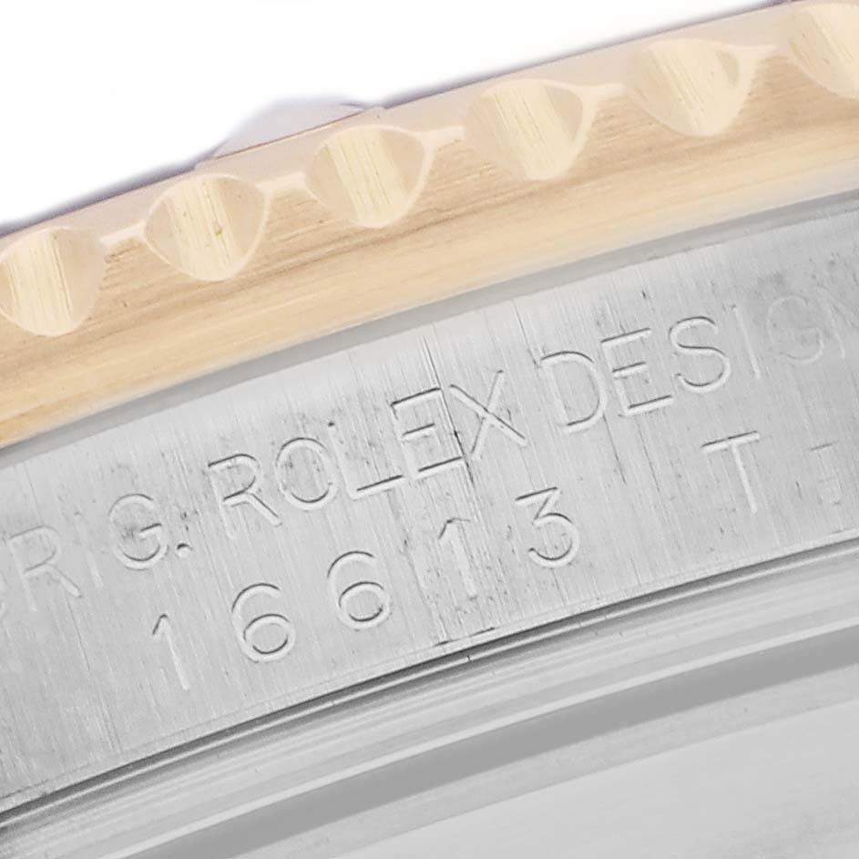 The image shows a close-up of the Rolex Submariner 16613 Men
s Steel and Gold (two tone) Blue Dial 16613 Men
s Steel and Gold (two tone) Blue Dial
s engraved bezel and case side, highlighting the model number.