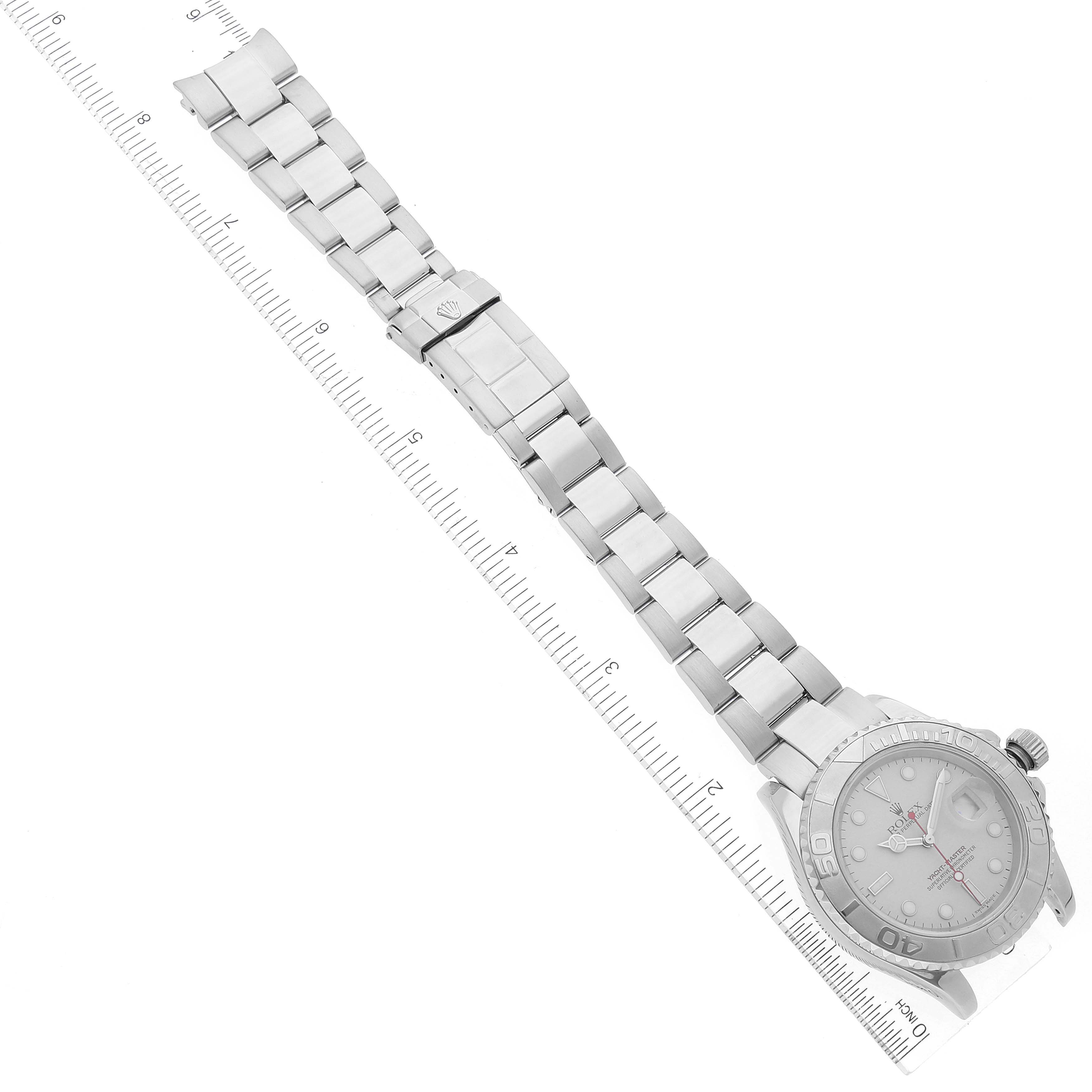 The image shows the Rolex Yacht-Master 16622 Men
s Stainless Steel Silver Dial 16622 Men
s Stainless Steel Silver Dial watch laid flat with its band extended alongside a ruler for scale.
