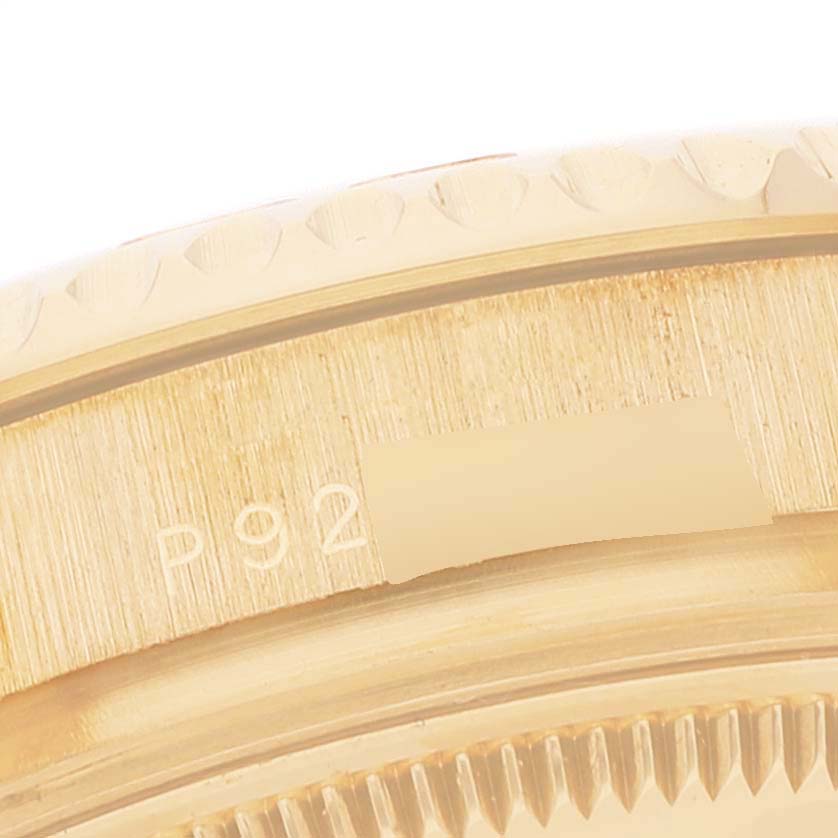 This image shows a close-up angle of the Rolex Yacht-Master 168628 Men
s Yellow Gold White Dial 168628 Men
s Yellow Gold White Dial
s bezel, highlighting part of its engraved serial number.