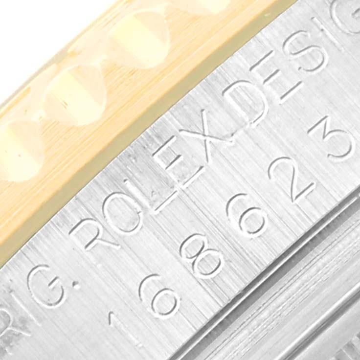 The image shows an angled close-up of the engravings and bezel edge on a Rolex Yacht-Master 168623 Men's Steel and Gold (two tone) White Dial 168623 Men's Steel and Gold (two tone) White Dial watch.