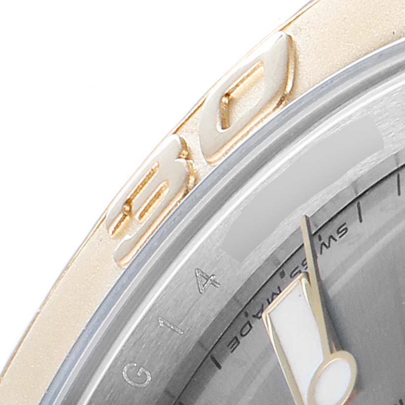 The image shows a close-up of the bezel and part of the dial of the Rolex Yacht-Master 16623 Men
s Steel and Gold (two tone) Grey Dial 16623 Men
s Steel and Gold (two tone) Grey Dial watch.