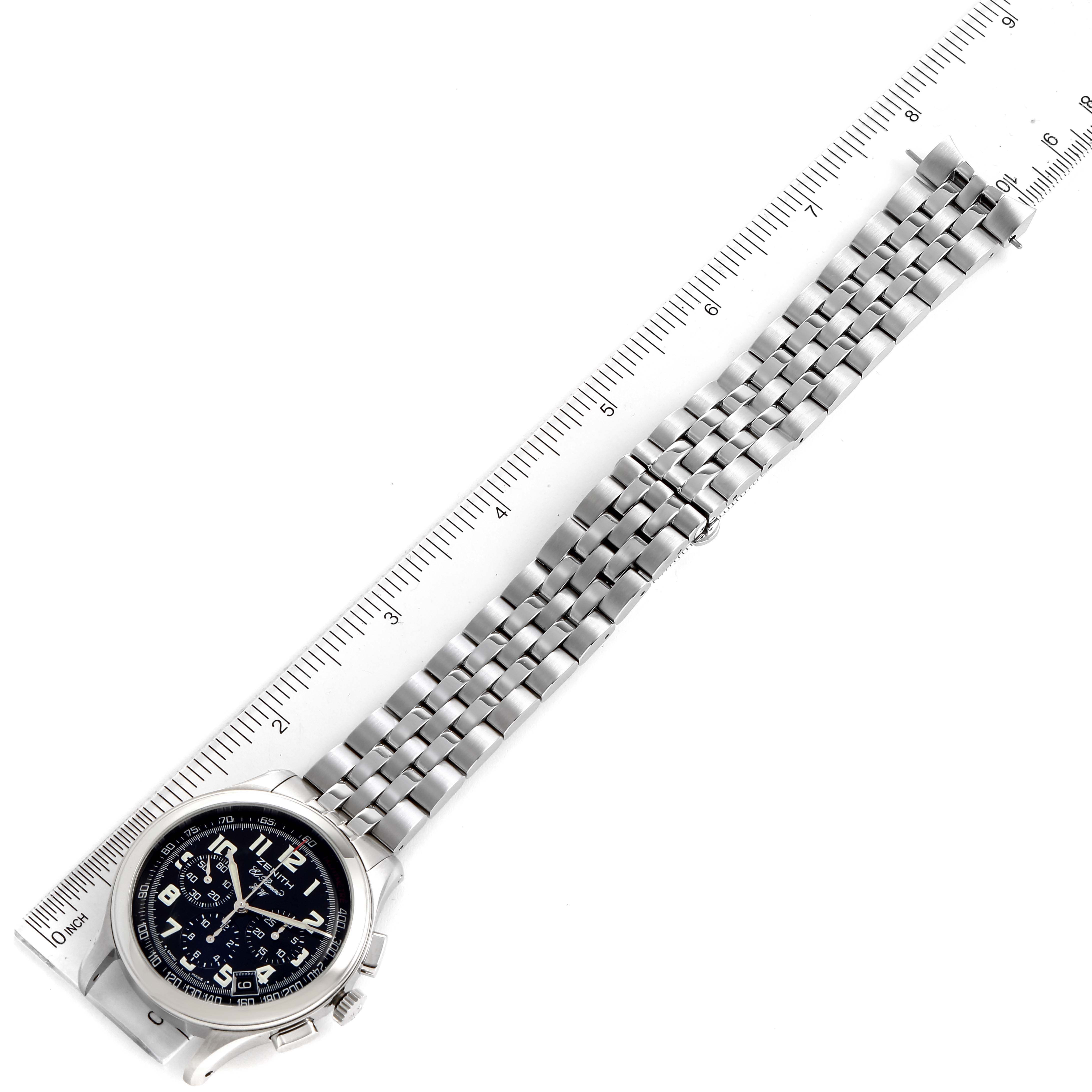 The image shows a Zenith El Primero 02.0500.420 Men's Stainless Steel Black Dial 02.0500.420 Men's Stainless Steel Black Dial watch laid flat with a ruler, displaying its face and metal bracelet.