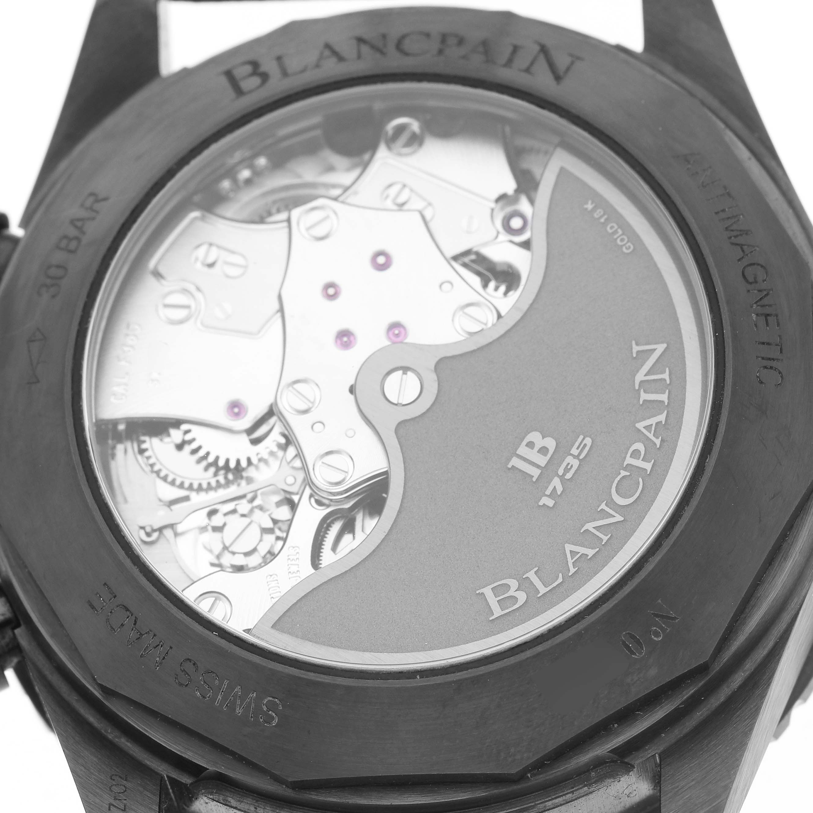 The image shows the backside of a Blancpain Fifty Fathoms 5200-0153-B52A Men's Ceramic Green Dial watch displaying its movement through a transparent case back.