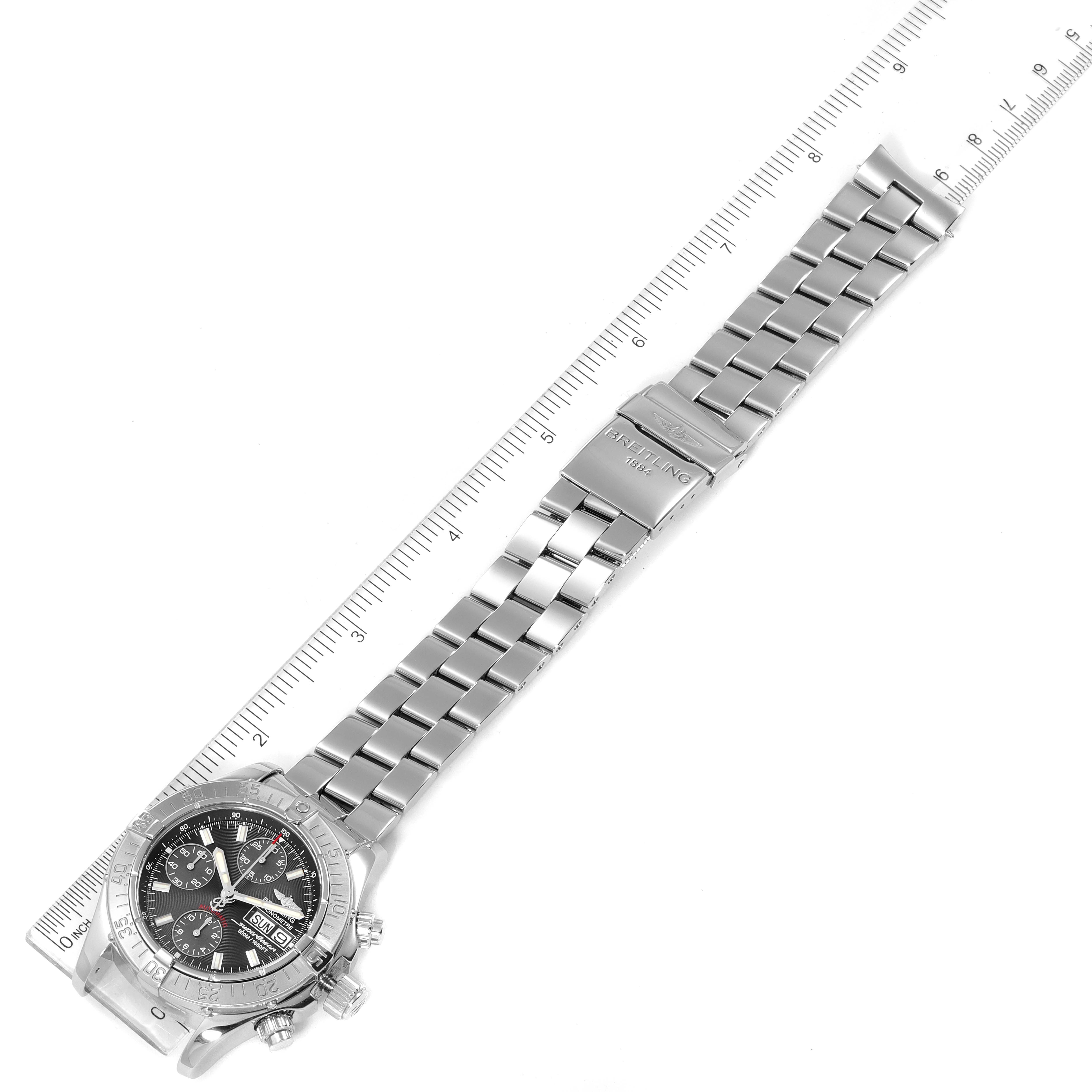 The image shows a Breitling Superocean A13340 Men's Stainless Steel Grey Dial A13340 Men's Stainless Steel Grey Dial watch laid flat with the strap and clasp visible alongside a measuring ruler.